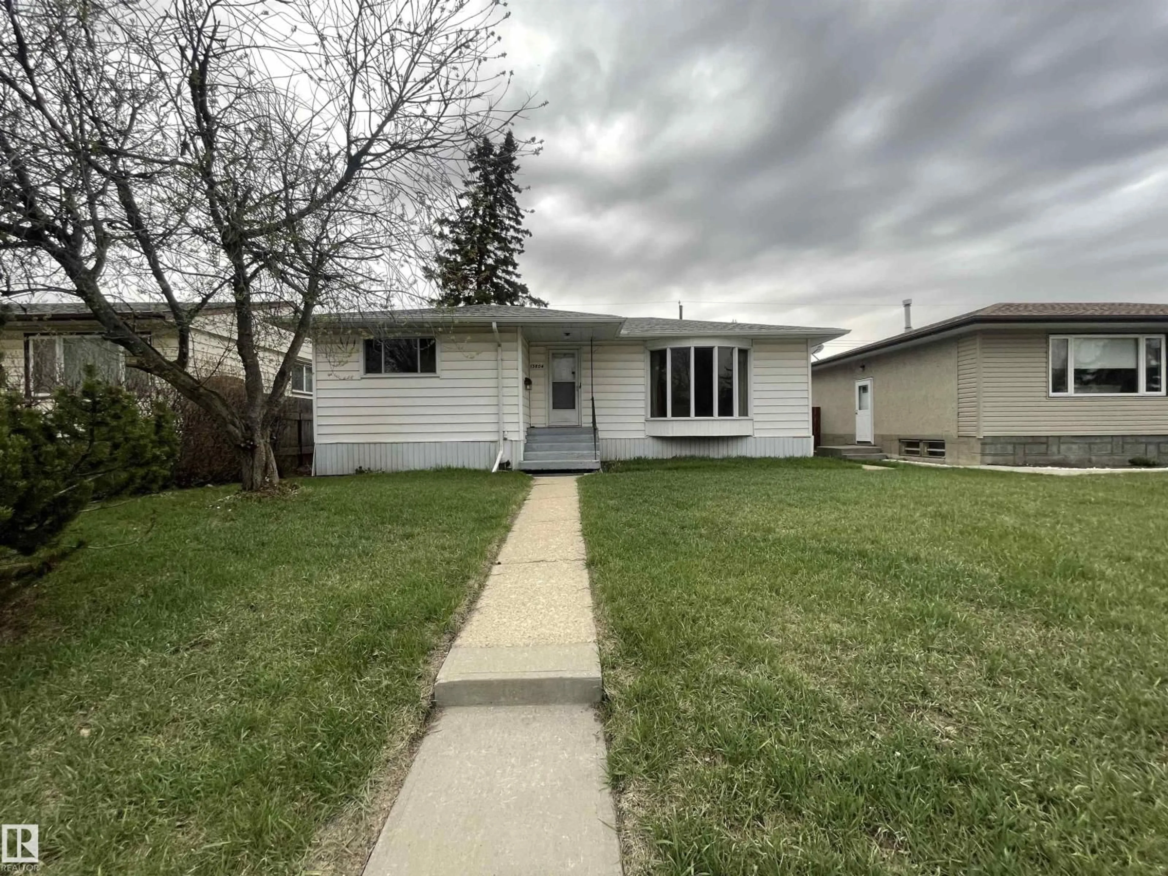 Home with vinyl exterior material, street for 13804 132 AV, Edmonton Alberta T5L3R8