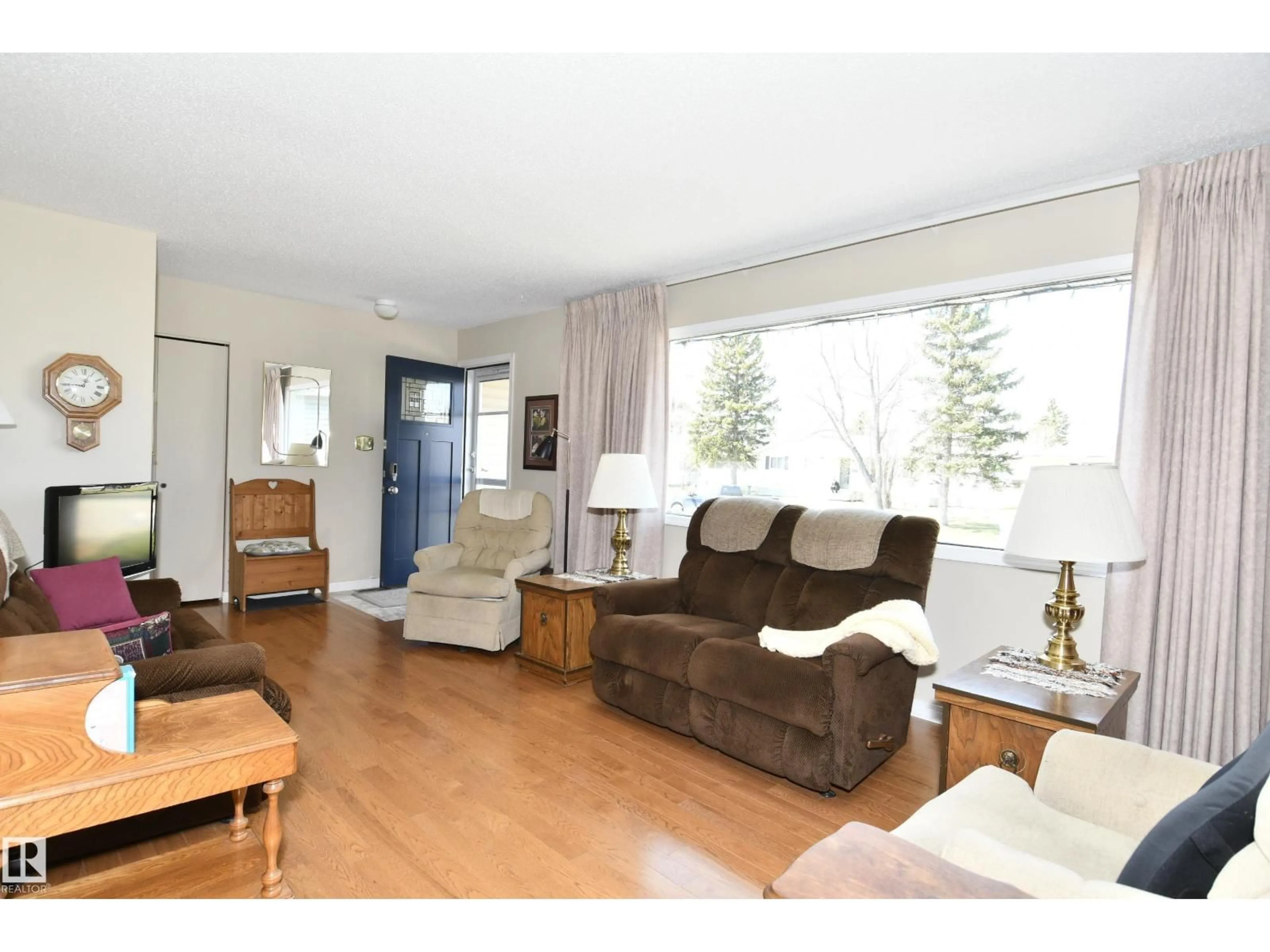 Living room with furniture, wood/laminate floor for 10 ATHAPASKAN DR, Leduc Alberta T9E4N2