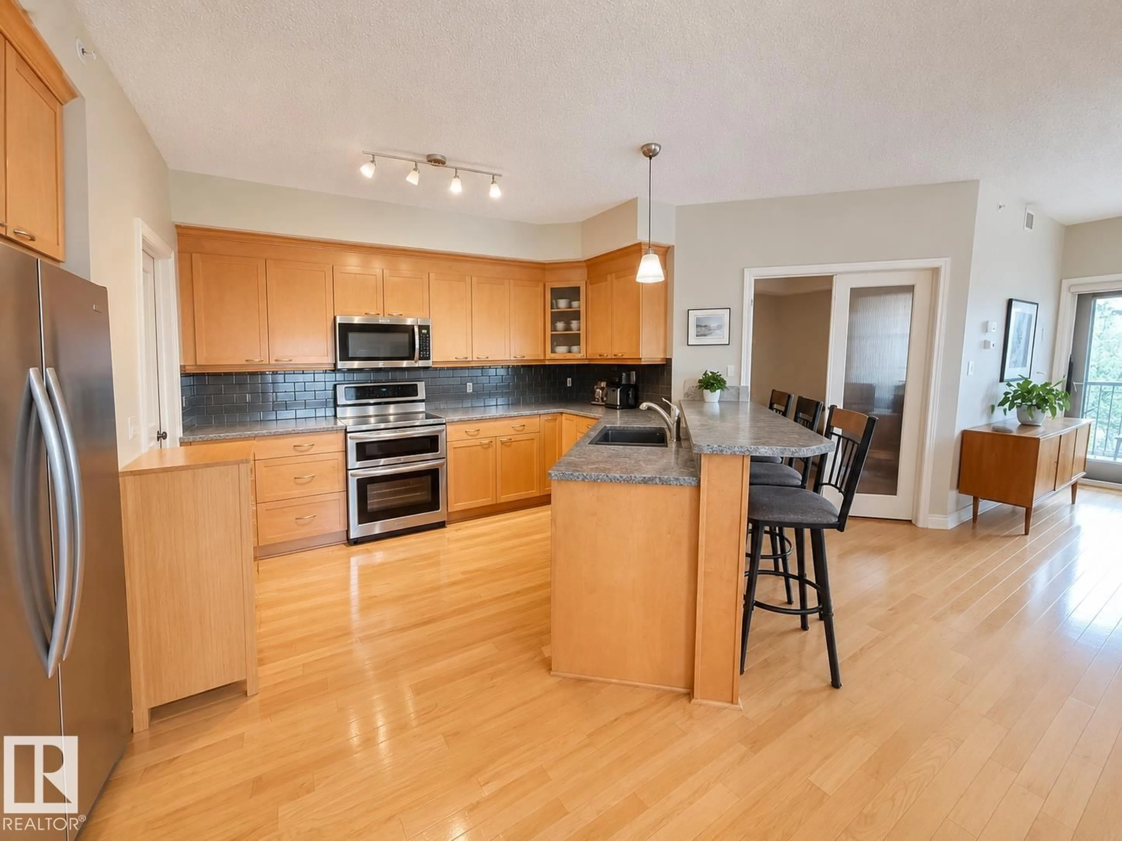 Open concept kitchen, wood/laminate floor for #301 - 9803 96A ST NW, Edmonton Alberta T6A4A5
