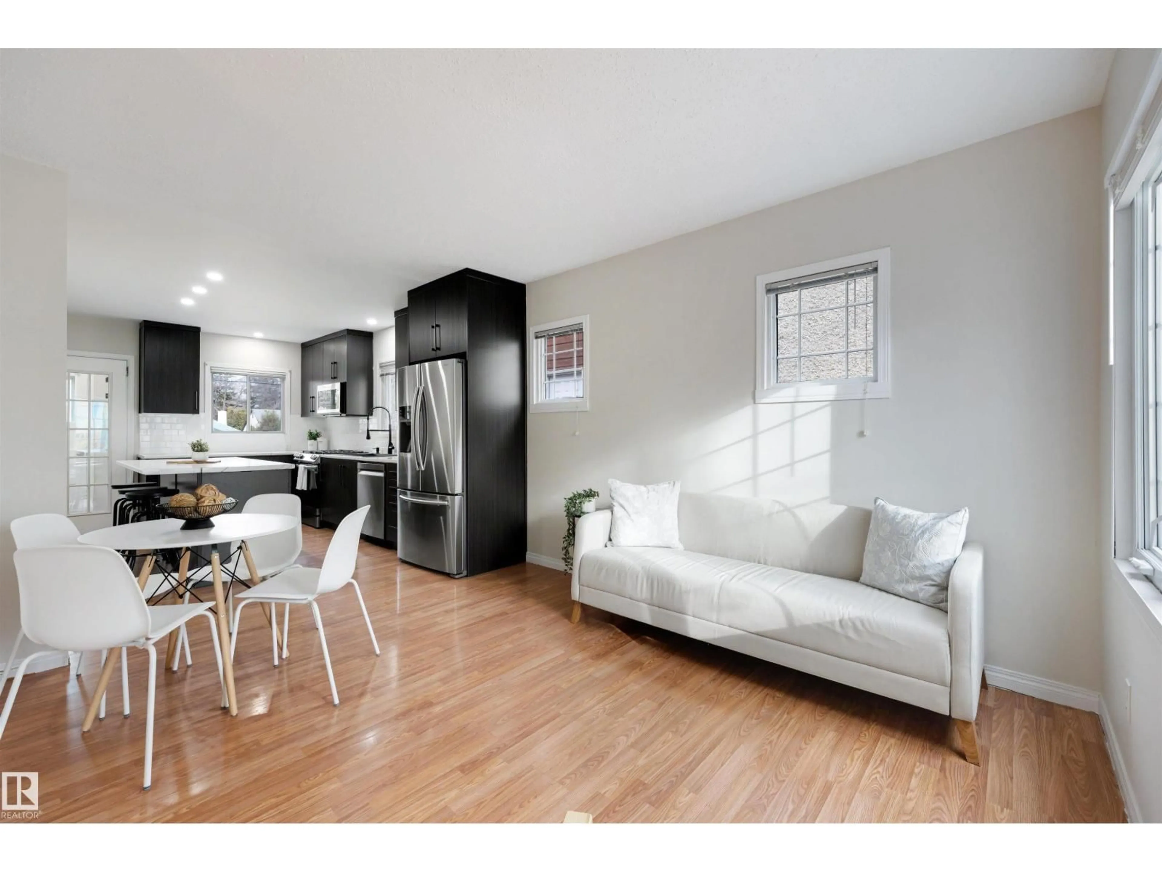 Open concept kitchen, wood/laminate floor for 11421 68 ST, Edmonton Alberta T5B1P1