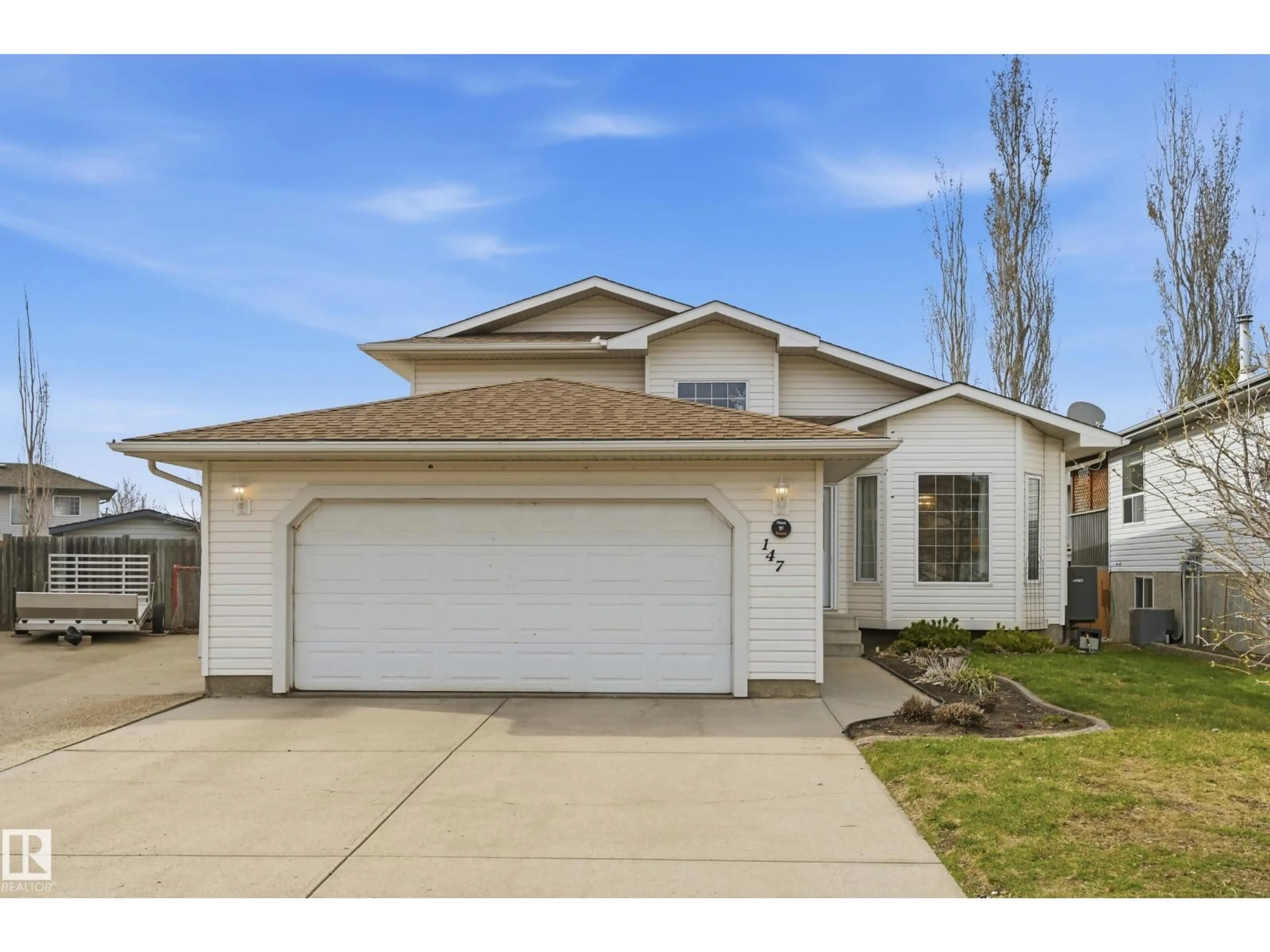 Home with vinyl exterior material, street for 147 WESTMEWS DR, Fort Saskatchewan Alberta T8L4H9