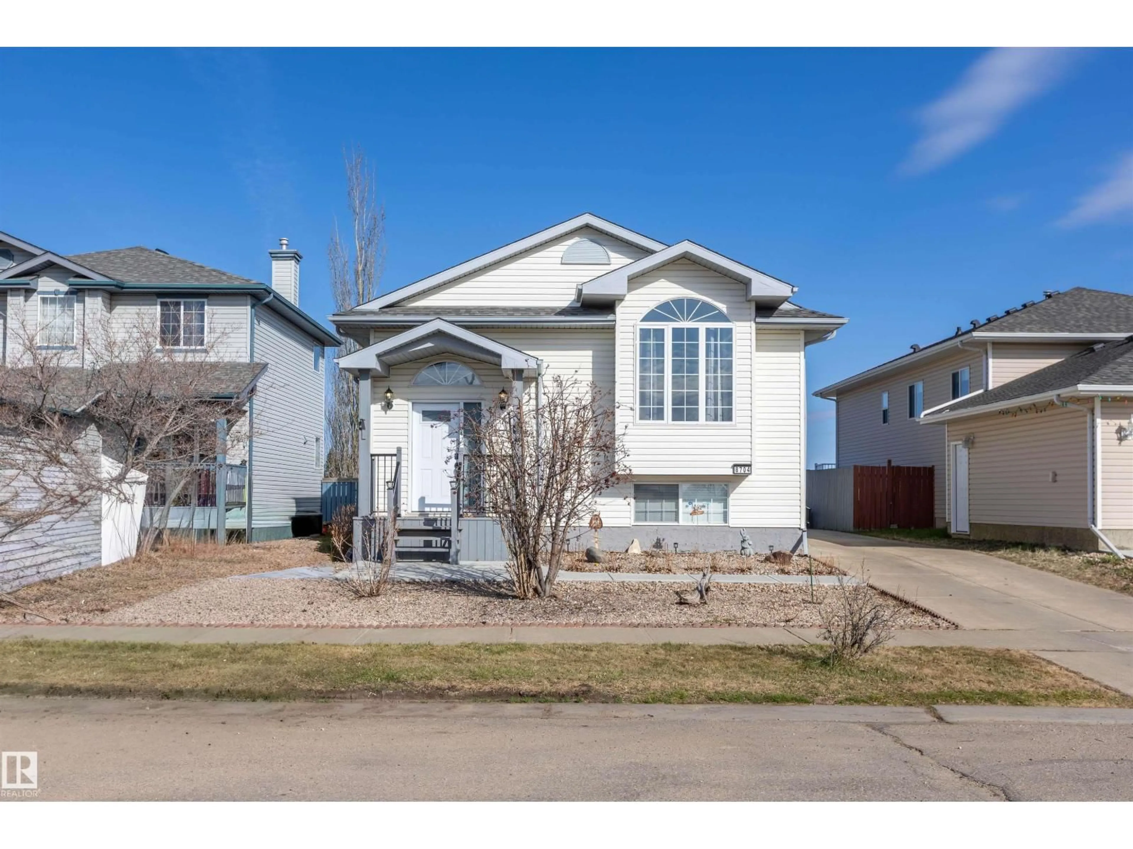 Home with vinyl exterior material, street for 8704 99 AV, Morinville Alberta T8R1S8
