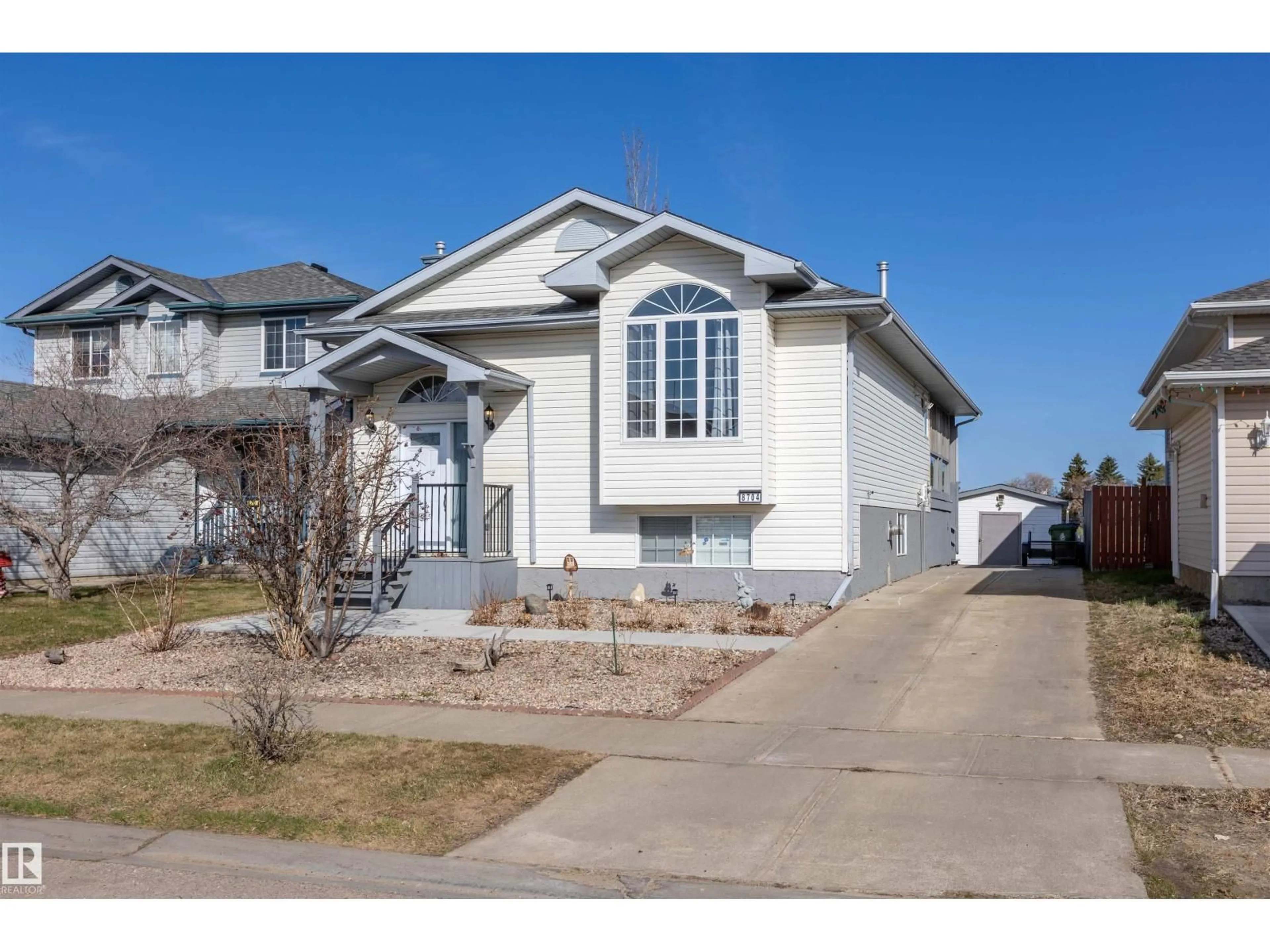 Home with vinyl exterior material, street for 8704 99 AV, Morinville Alberta T8R1S8