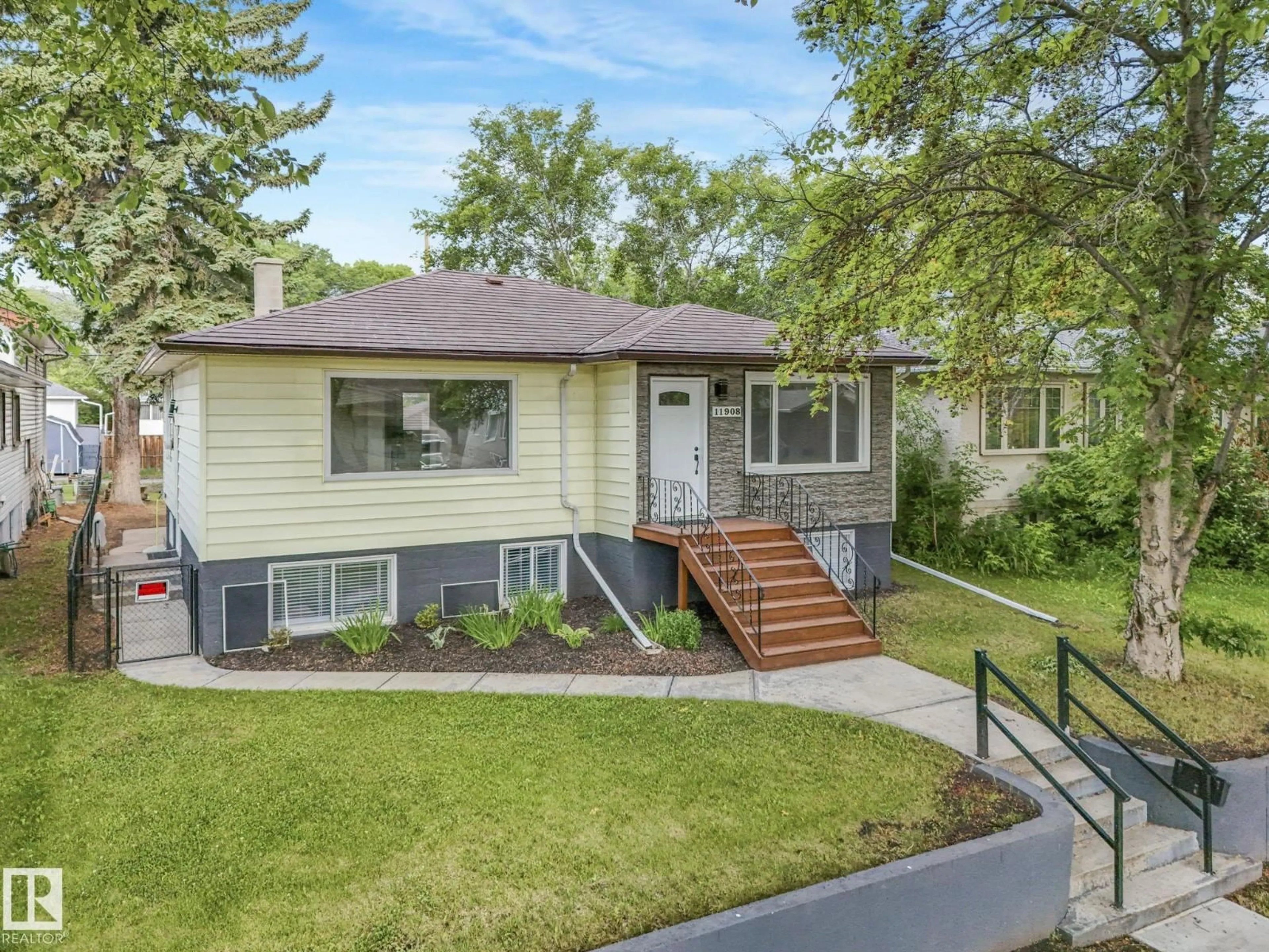 Home with vinyl exterior material, street for NW - 11908 52 ST, Edmonton Alberta T5W3J6