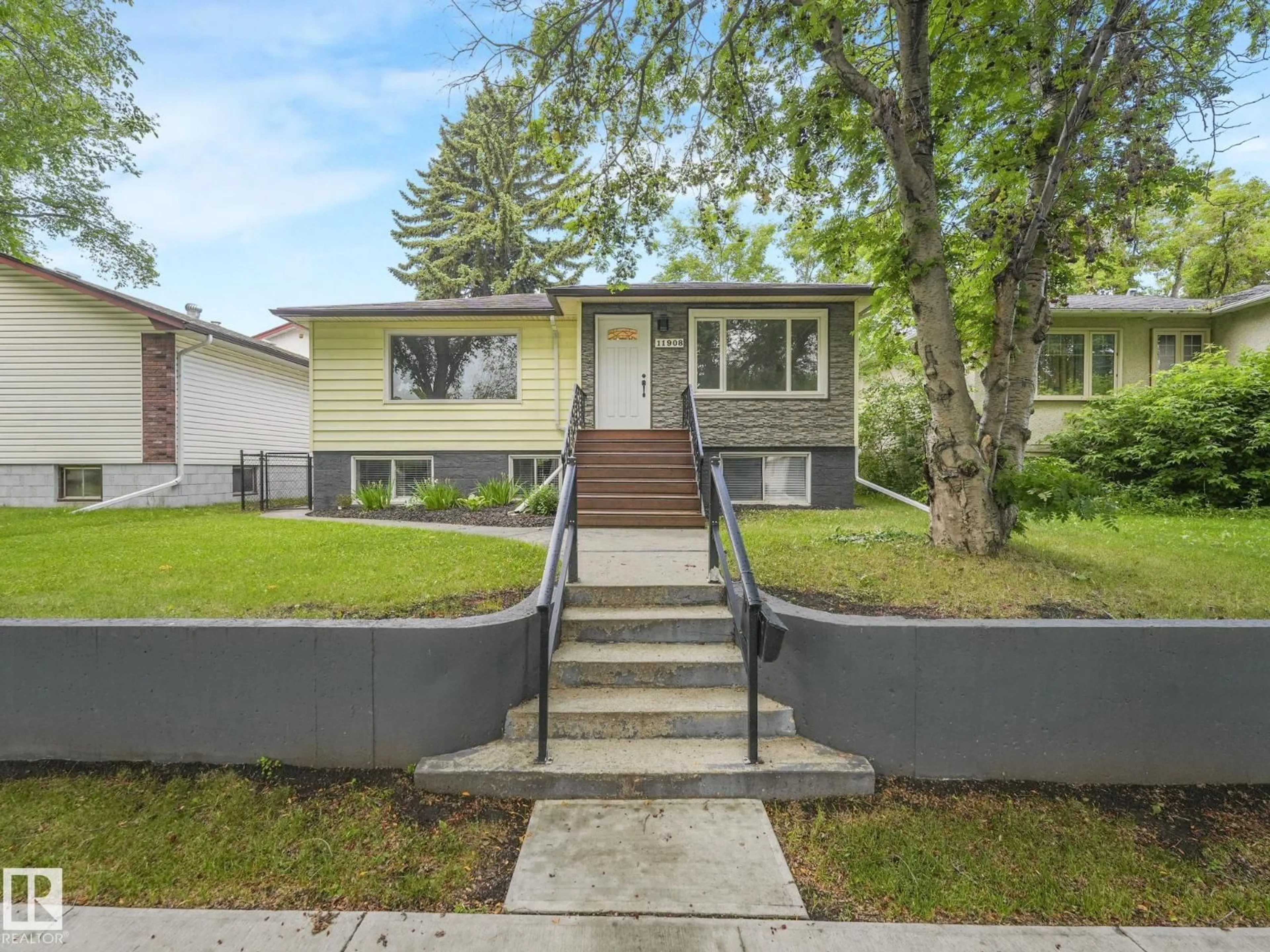 Home with vinyl exterior material, street for NW - 11908 52 ST, Edmonton Alberta T5W3J6