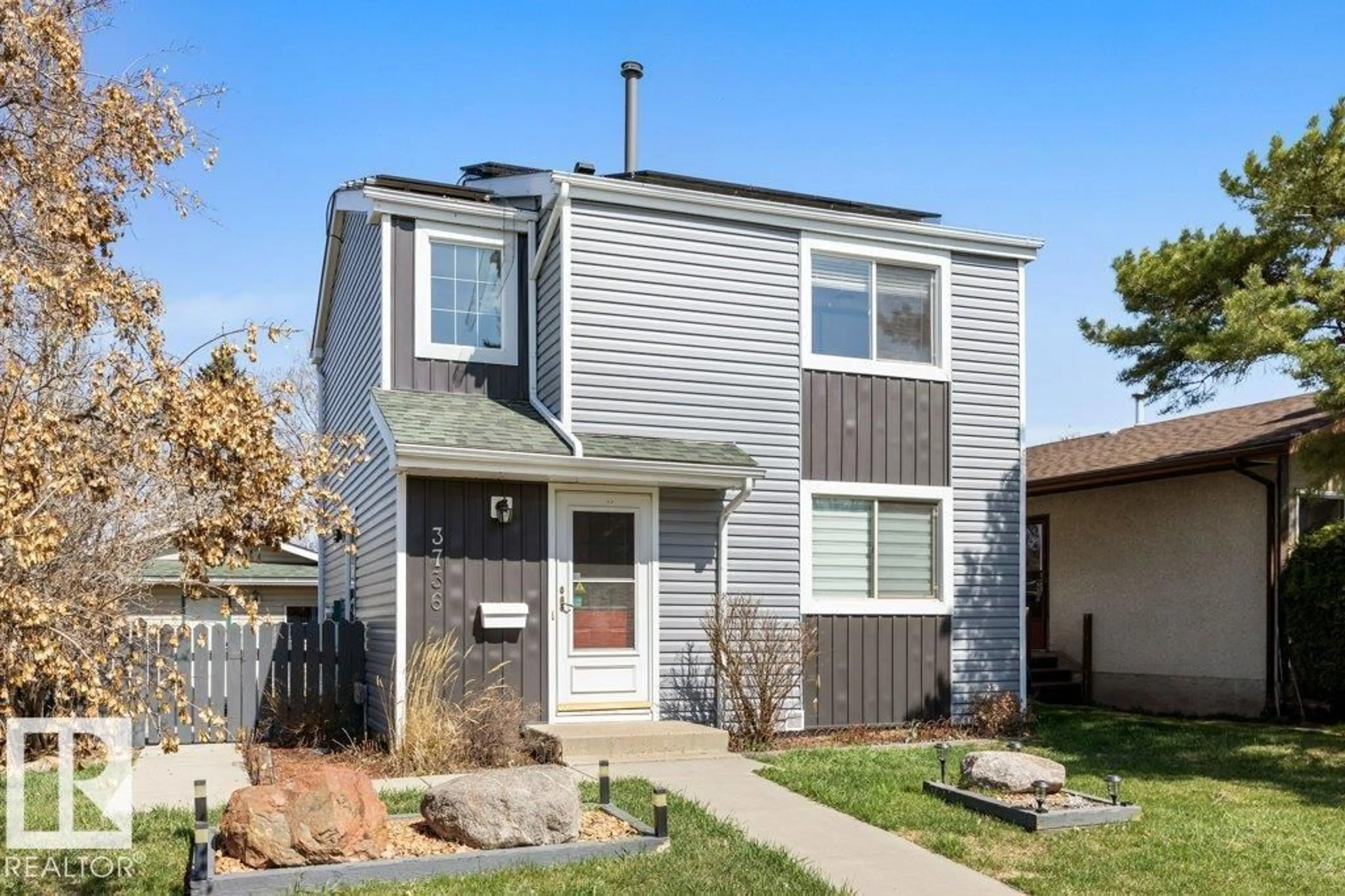 Home with vinyl exterior material, street for 3736 12 AV, Edmonton Alberta T6L3B2
