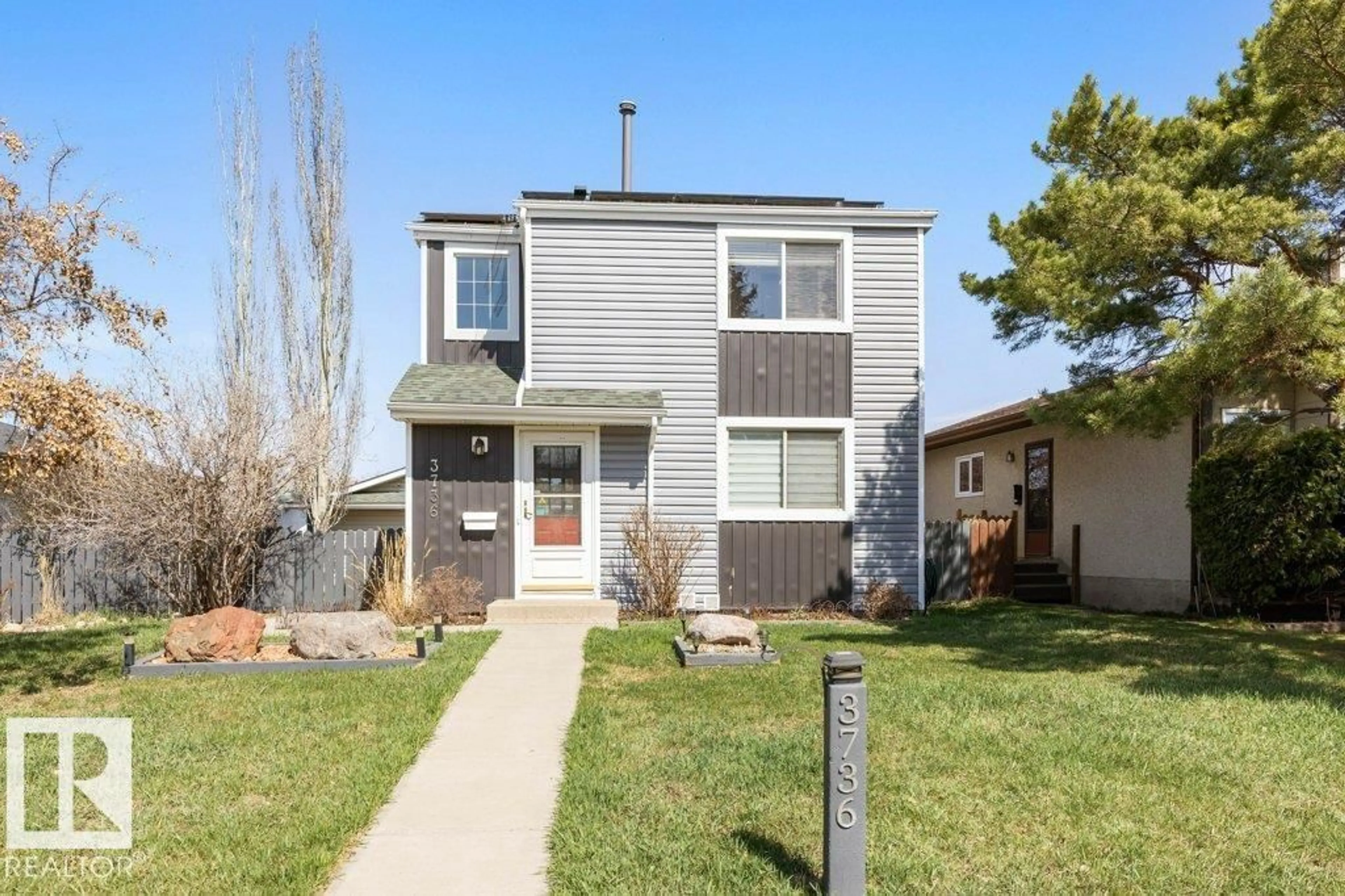 Home with vinyl exterior material, street for 3736 12 AV, Edmonton Alberta T6L3B2