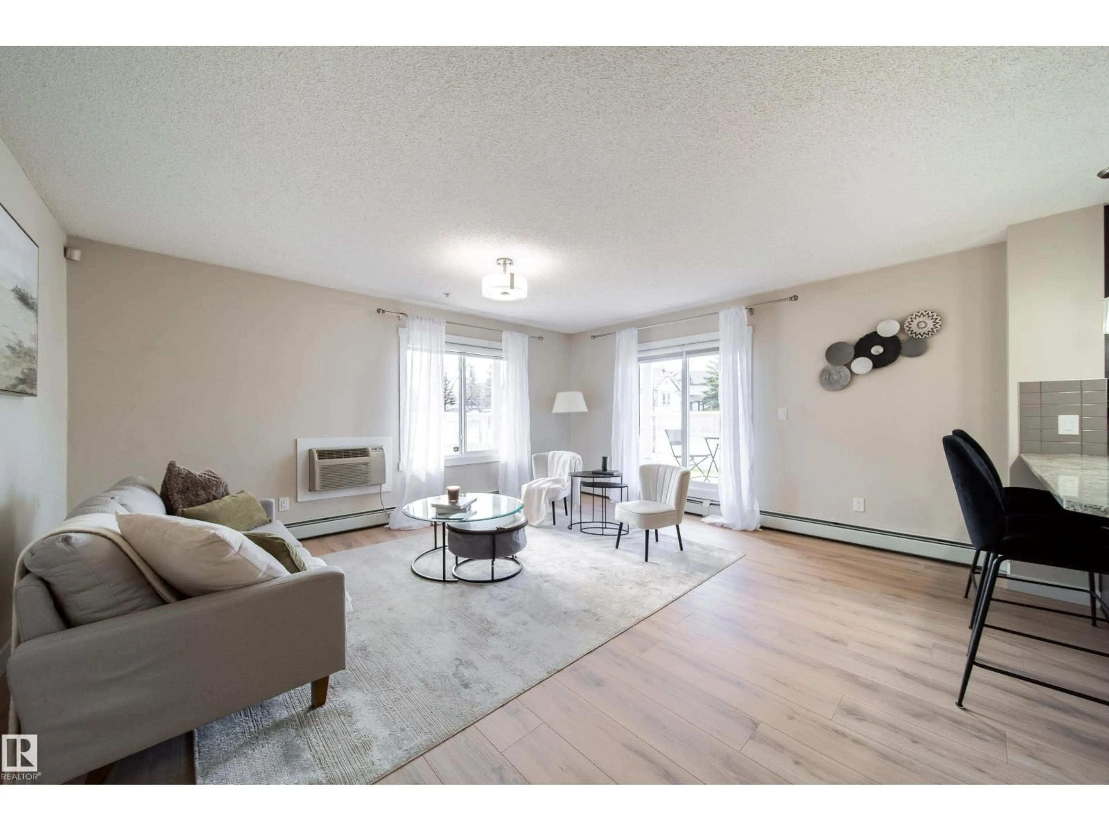 Living room with furniture, wood/laminate floor for 117 - 2229 44 AV, Edmonton Alberta T6T0W6