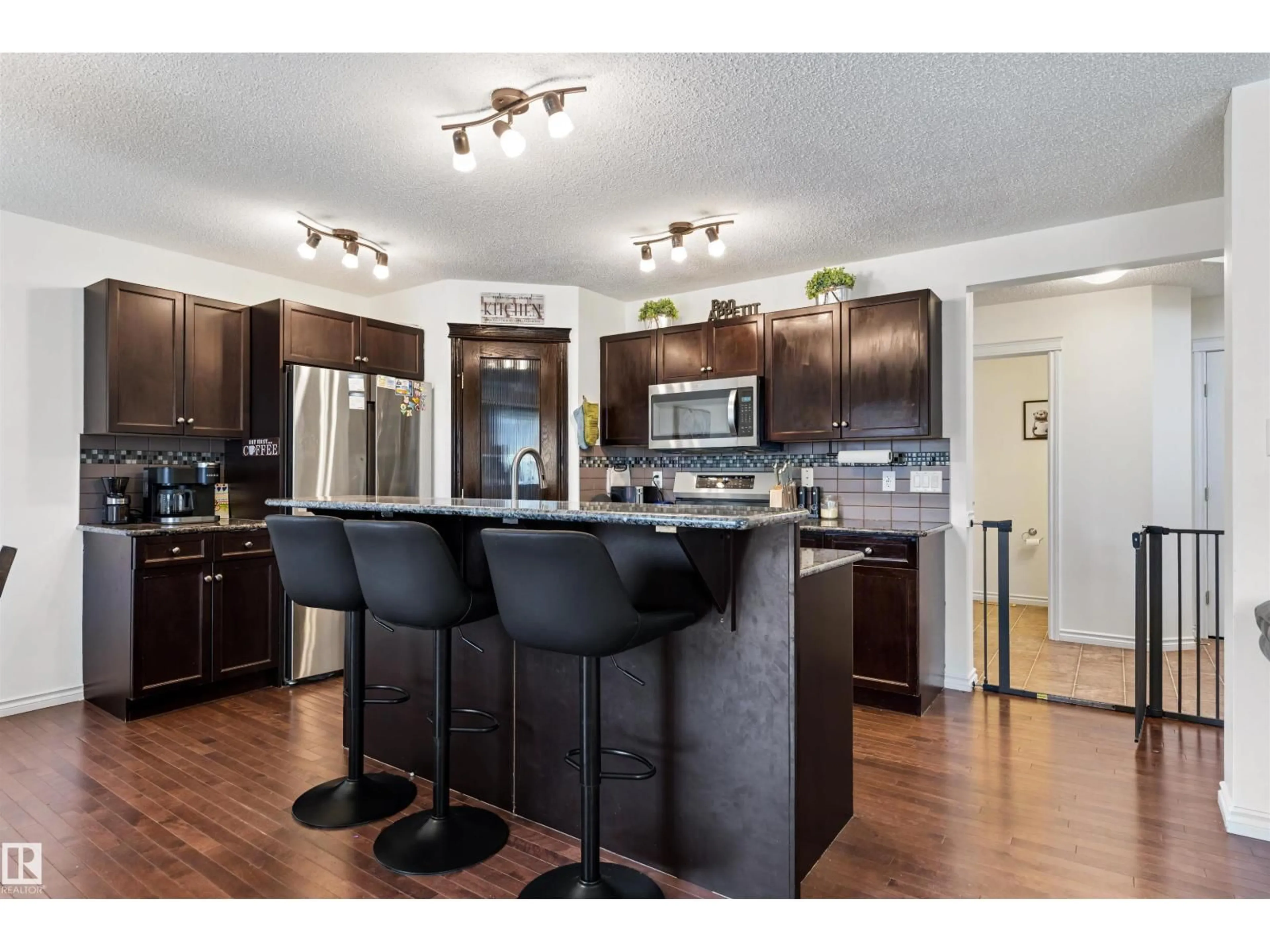 Open concept kitchen, wood/laminate floor for 6115 18 AV, Edmonton Alberta T6X0W3