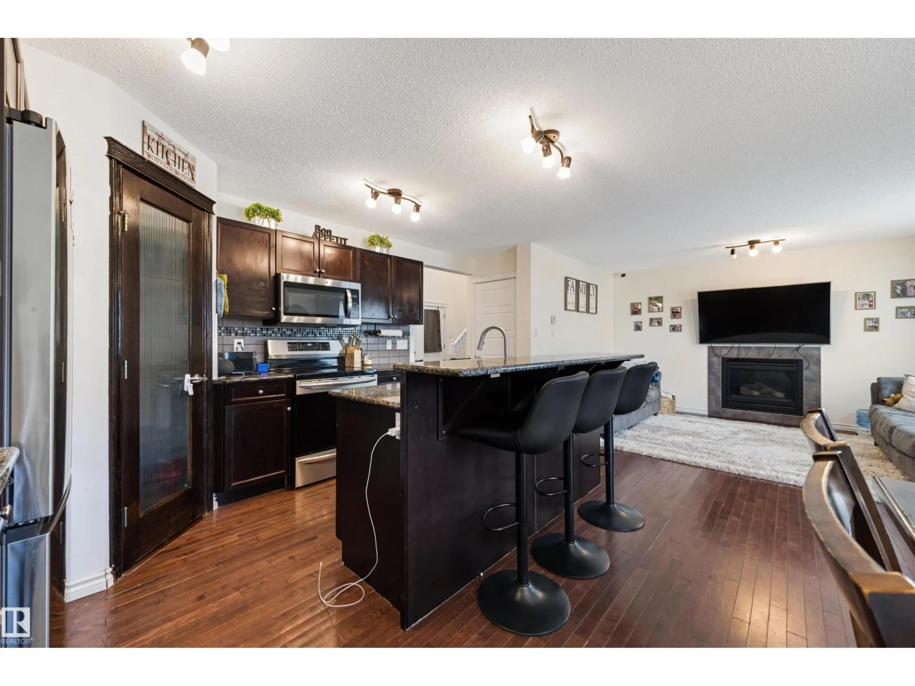Open concept kitchen, wood/laminate floor for 6115 18 AV, Edmonton Alberta T6X0W3