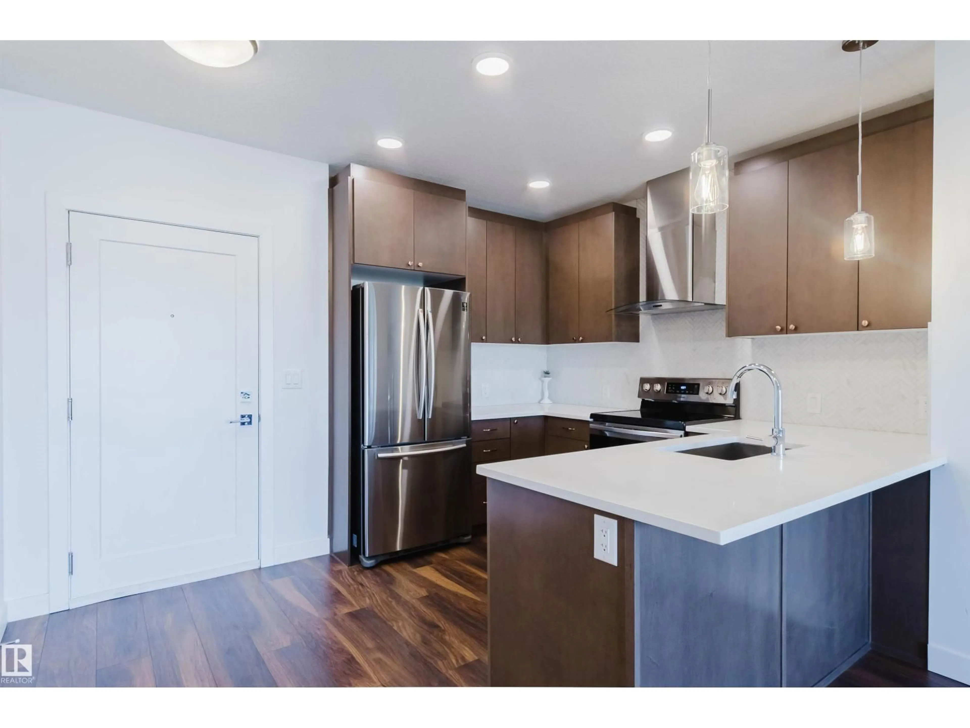 Open concept kitchen, wood/laminate floor for 205 - 1316 WINDERMERE WY, Edmonton Alberta T6W2J3