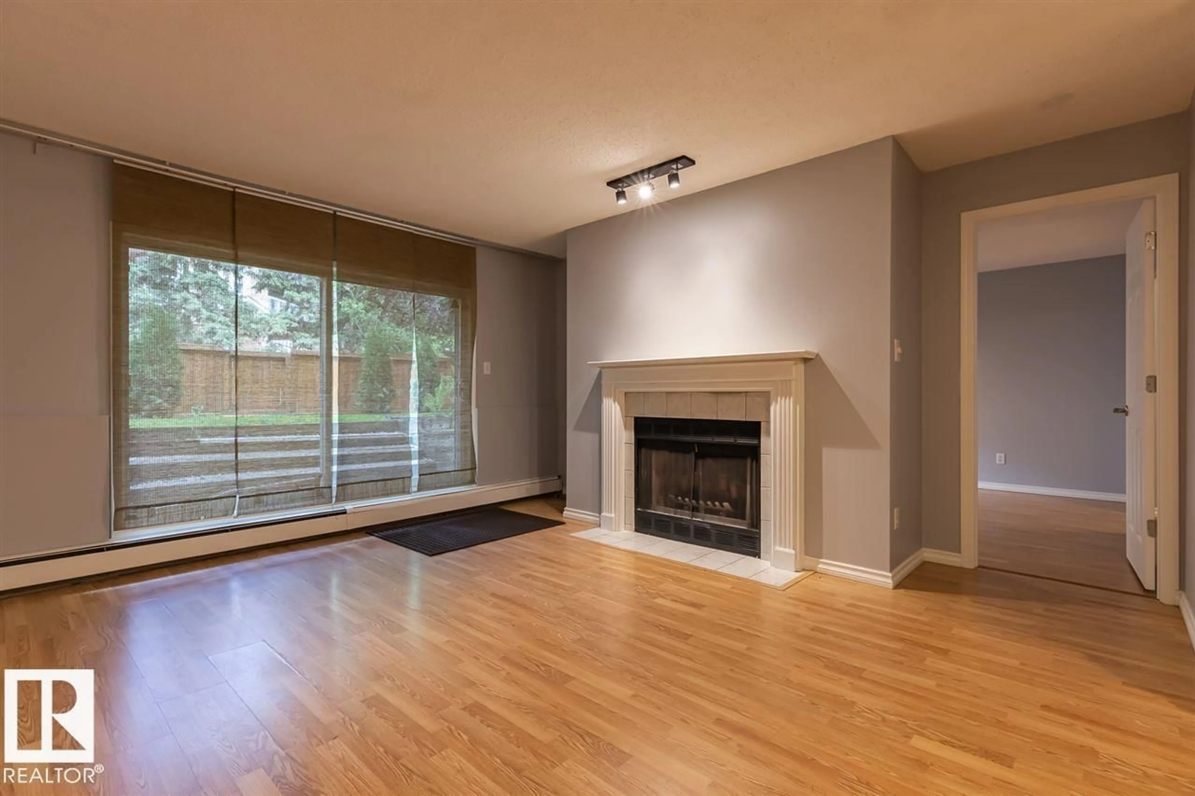 Living room with furniture, wood/laminate floor for #108 - 9010 106 AV, Edmonton Alberta T5H2K3