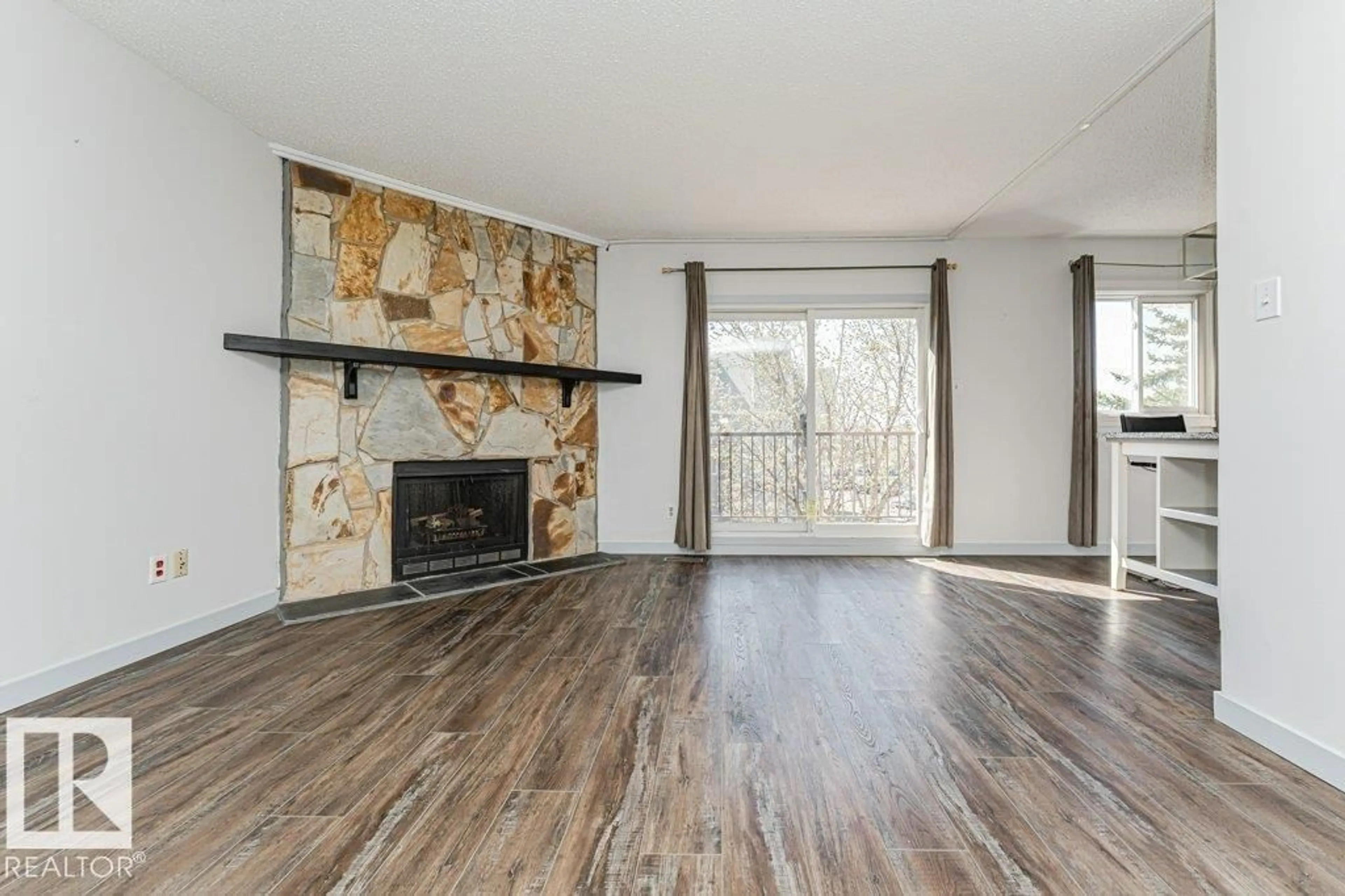 Living room with furniture, wood/laminate floor for 308 14004 26 ST, Edmonton Alberta T5Y1Y4