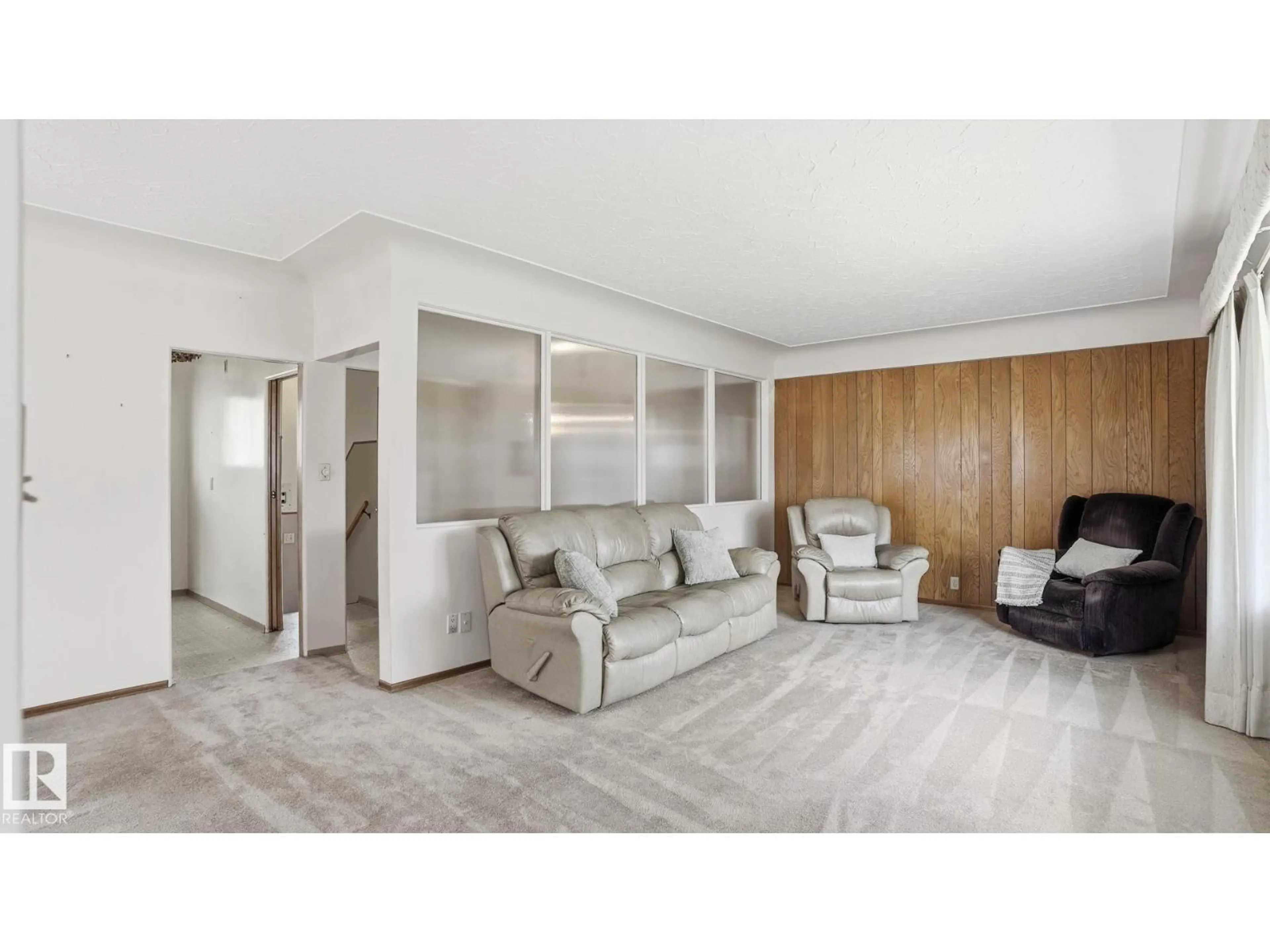 Living room with furniture, wood/laminate floor for 13024 SHERBROOKE AV, Edmonton Alberta T5L4E8
