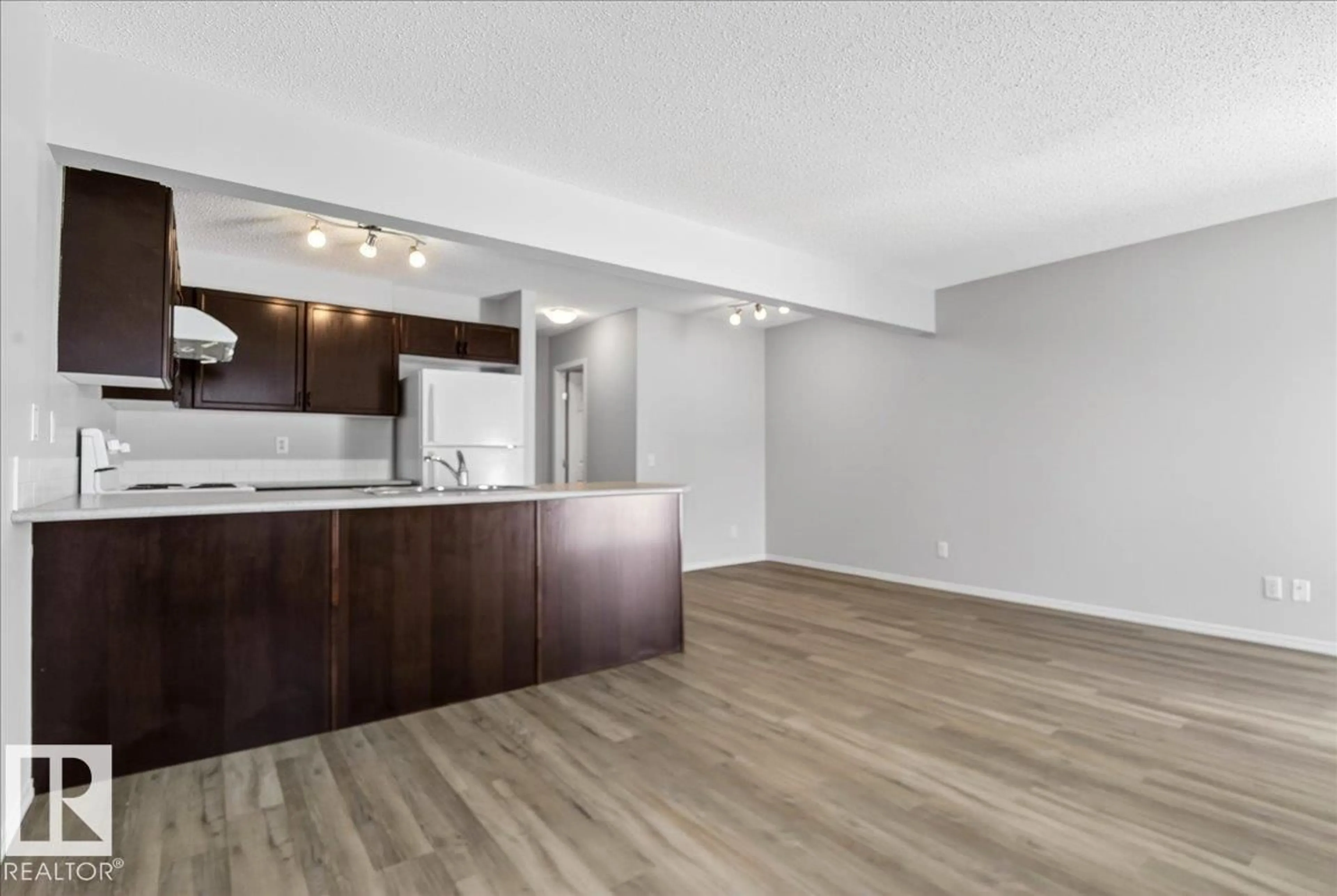 Open concept kitchen, wood/laminate floor for #7 - 18004 89 ST NW, Edmonton Alberta T5Z0E7