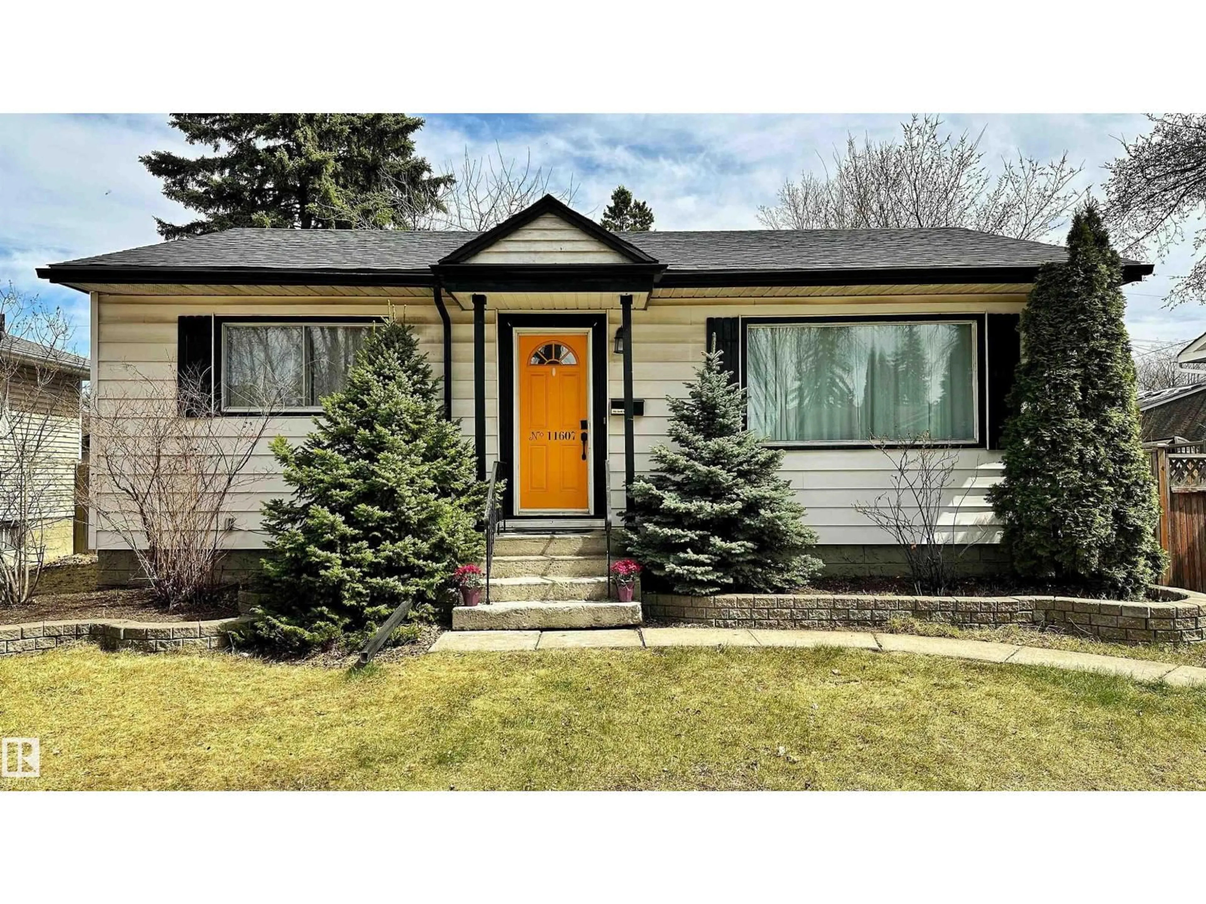 Home with vinyl exterior material, street for 11607 141 ST, Edmonton Alberta T5M1T7