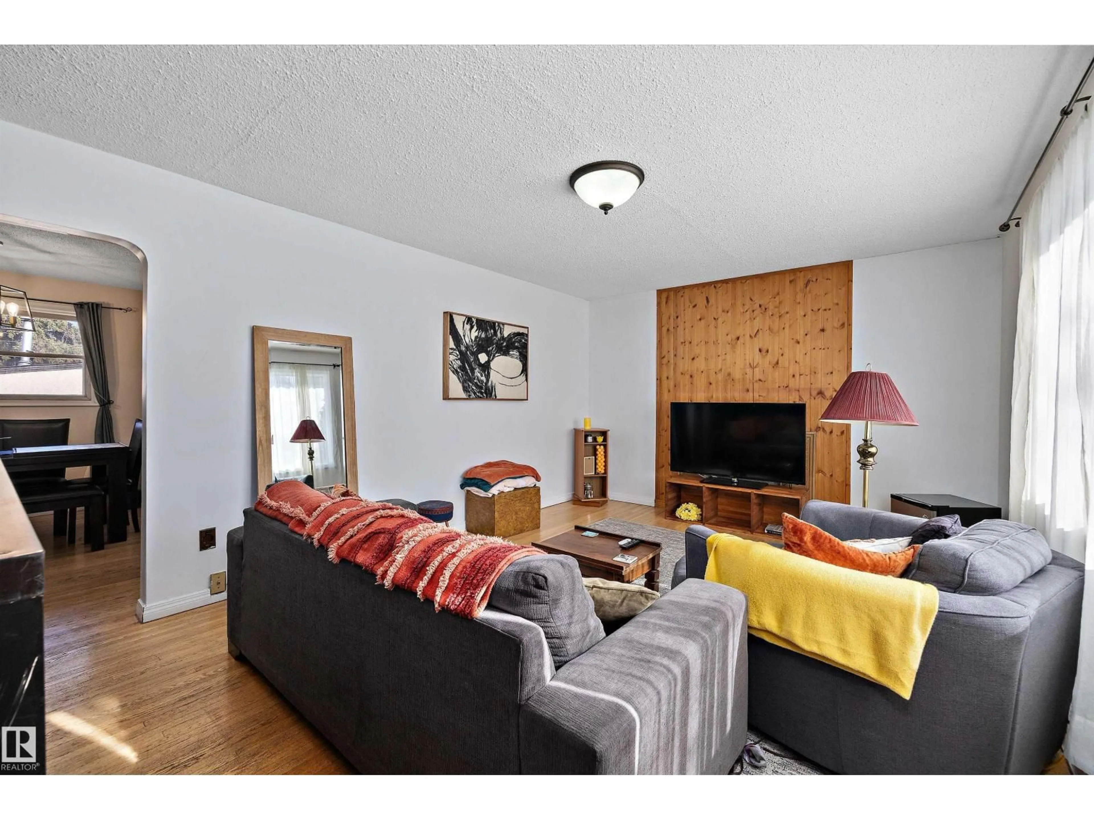 Living room with furniture, wood/laminate floor for 11607 141 ST, Edmonton Alberta T5M1T7