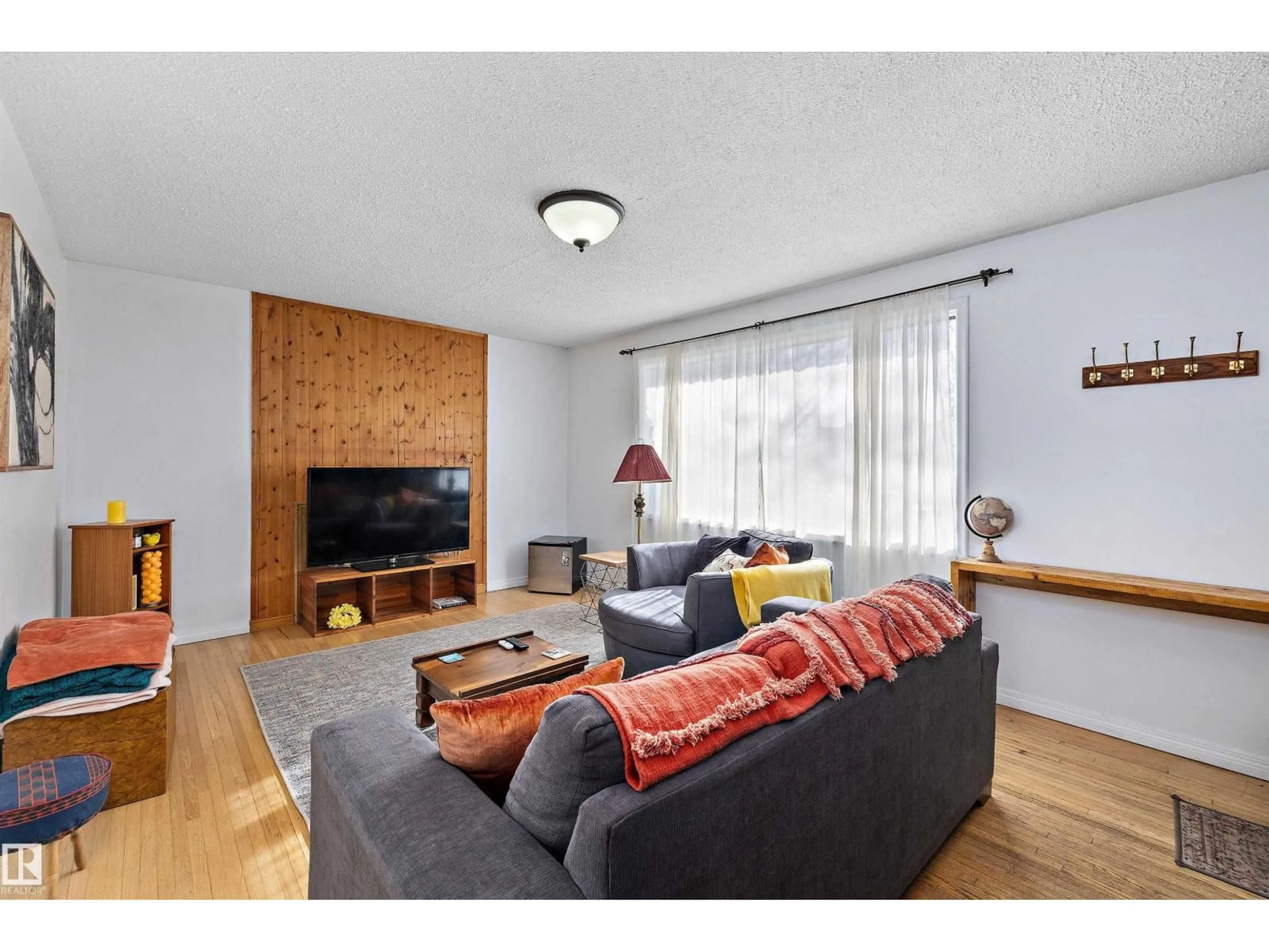 Living room with furniture, wood/laminate floor for 11607 141 ST, Edmonton Alberta T5M1T7