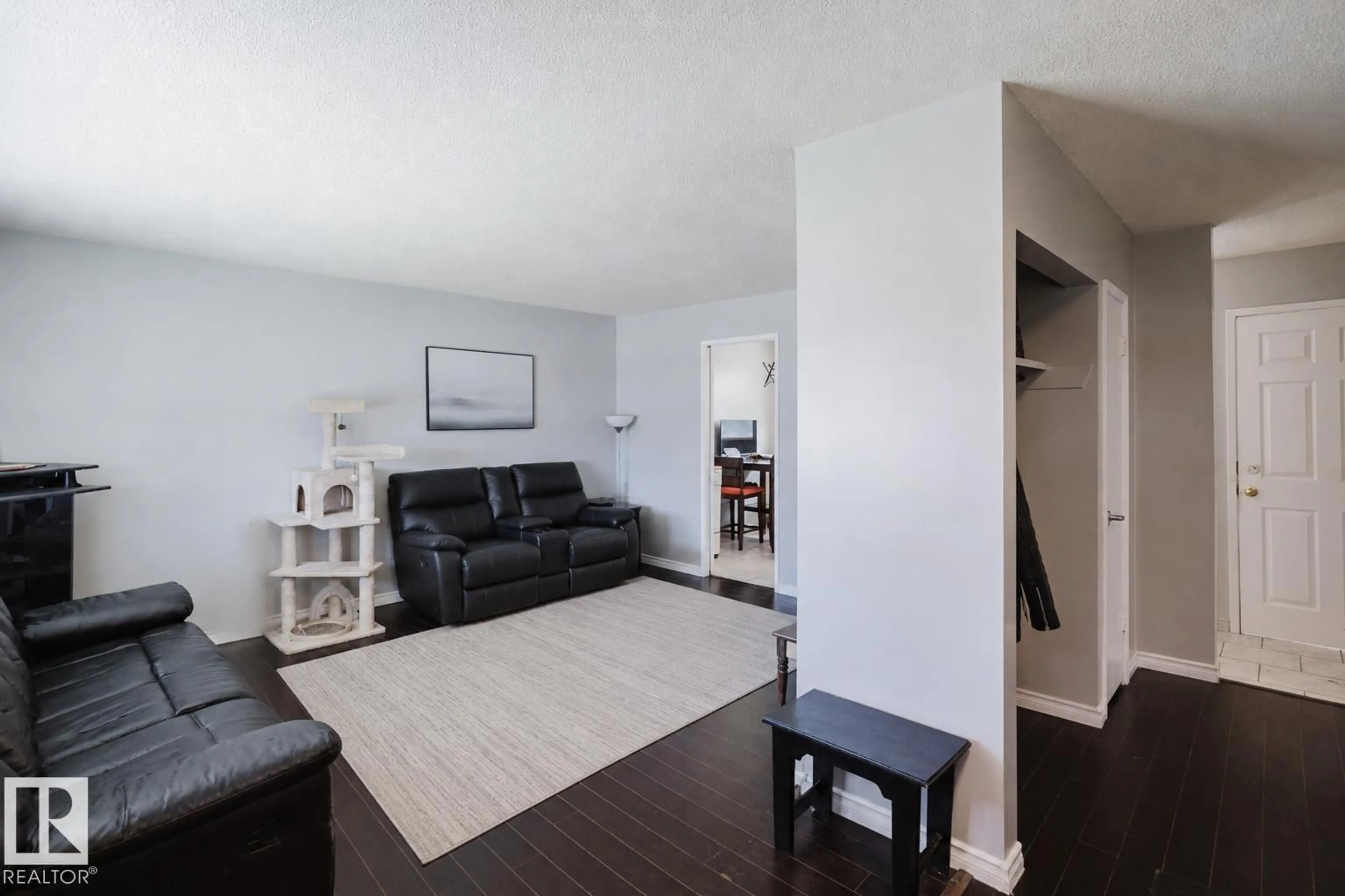 Living room with furniture, wood/laminate floor for NW - 10325 152 ST, Edmonton Alberta T5P1Y4