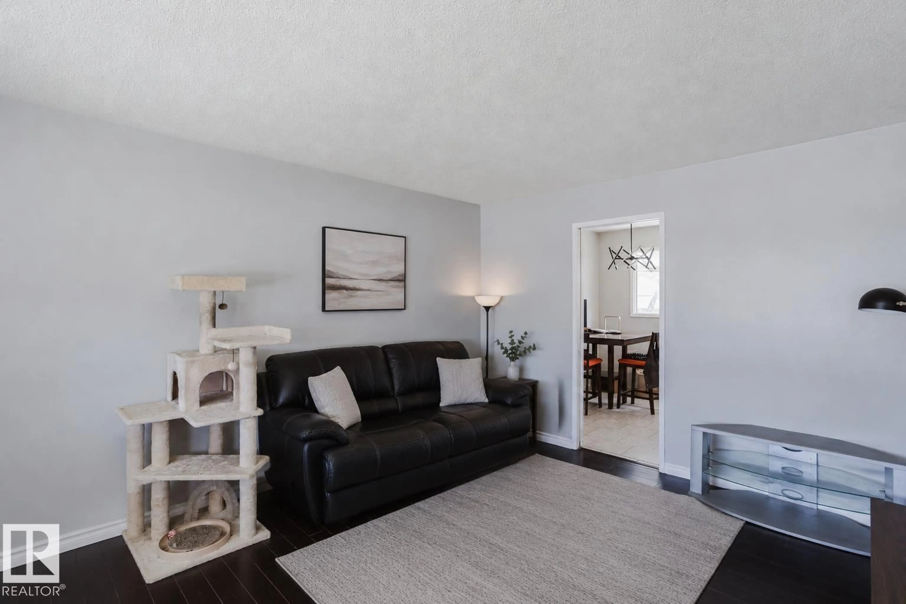 Living room with furniture, wood/laminate floor for NW - 10325 152 ST, Edmonton Alberta T5P1Y4