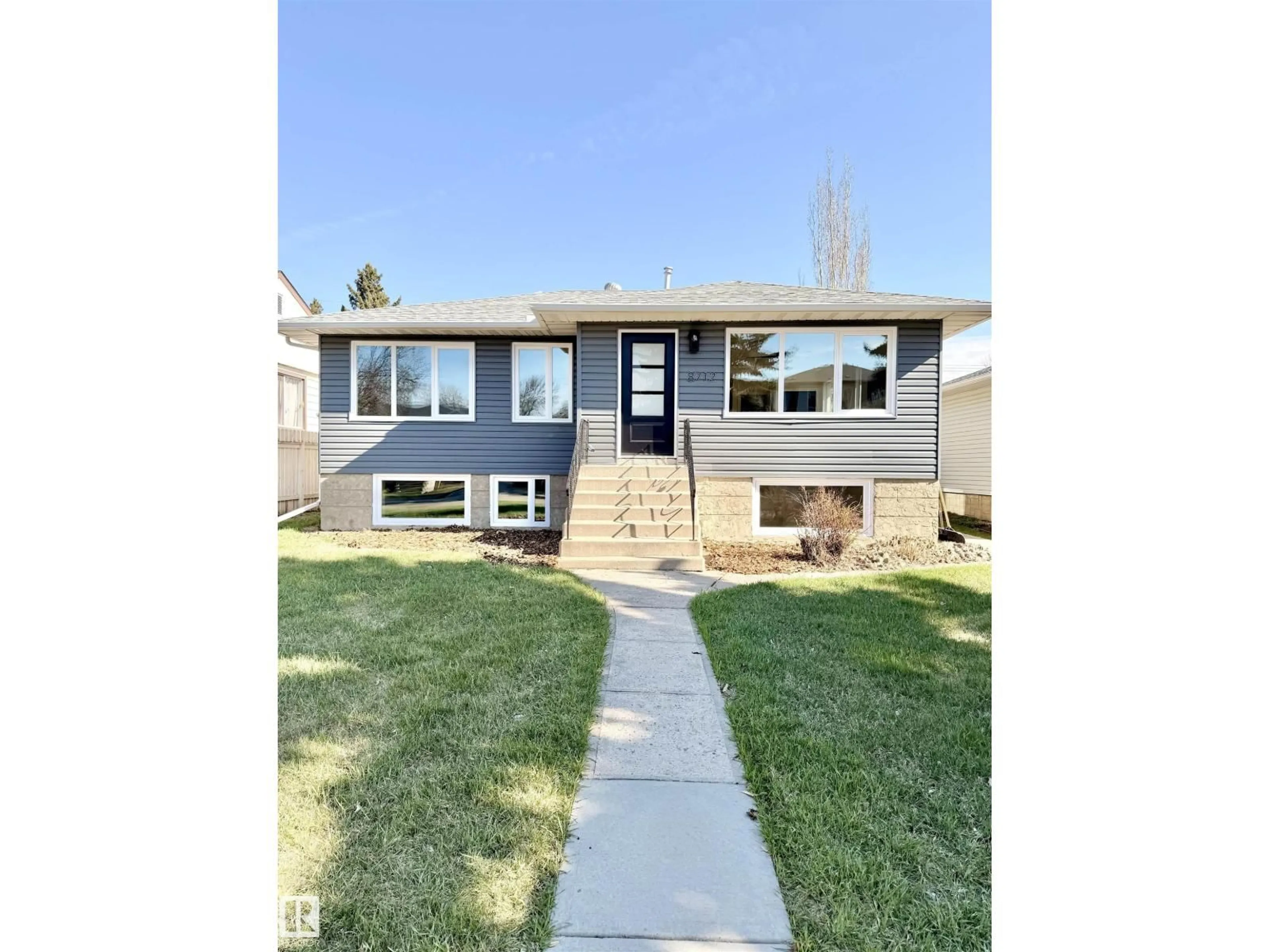 Home with vinyl exterior material, street for NW - 8712 89 AV, Edmonton Alberta T6C1N7