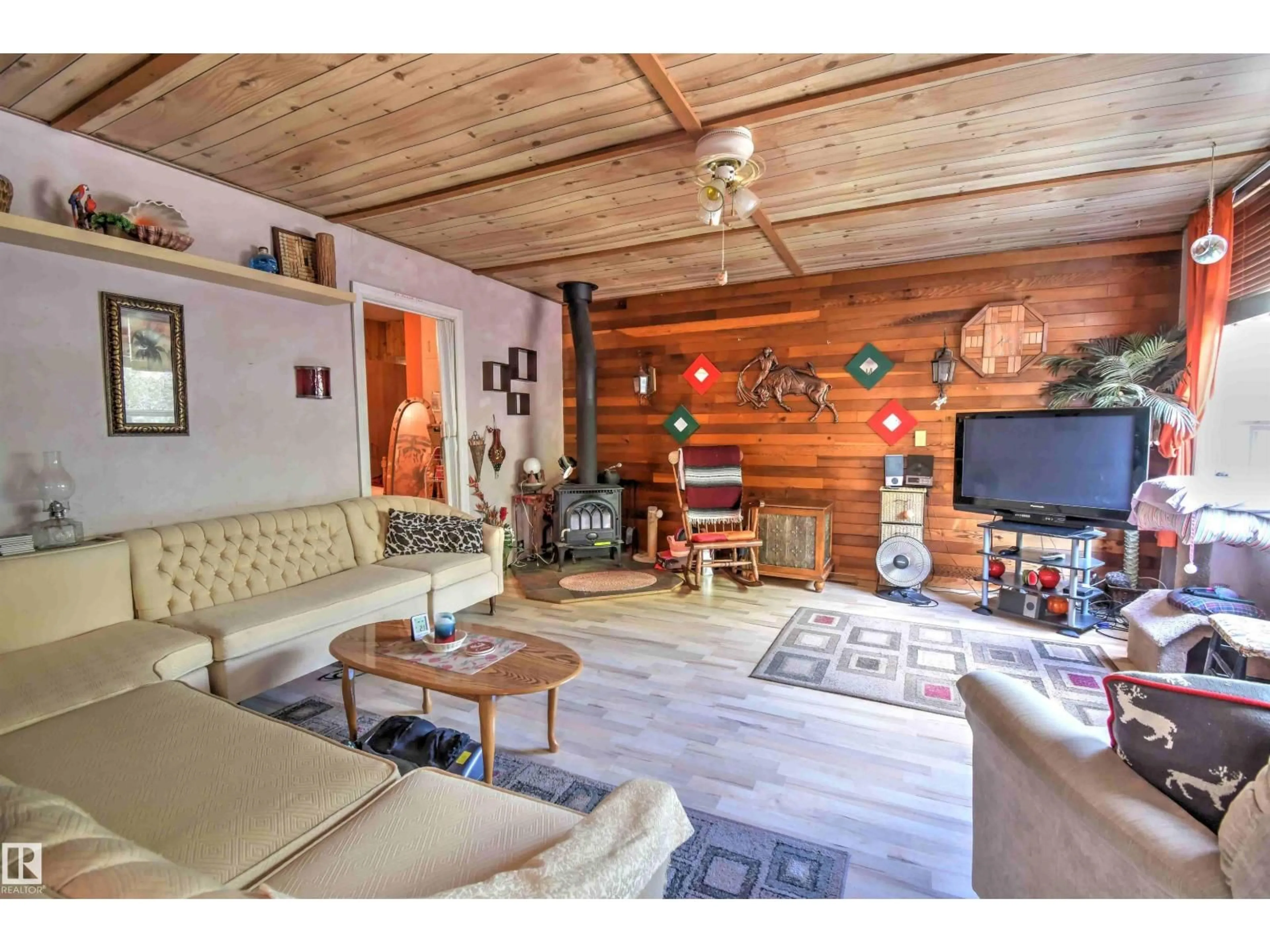 Living room with furniture, wood/laminate floor for 26 - 562007 RR 113, Rural Two Hills County Alberta T0B4K0
