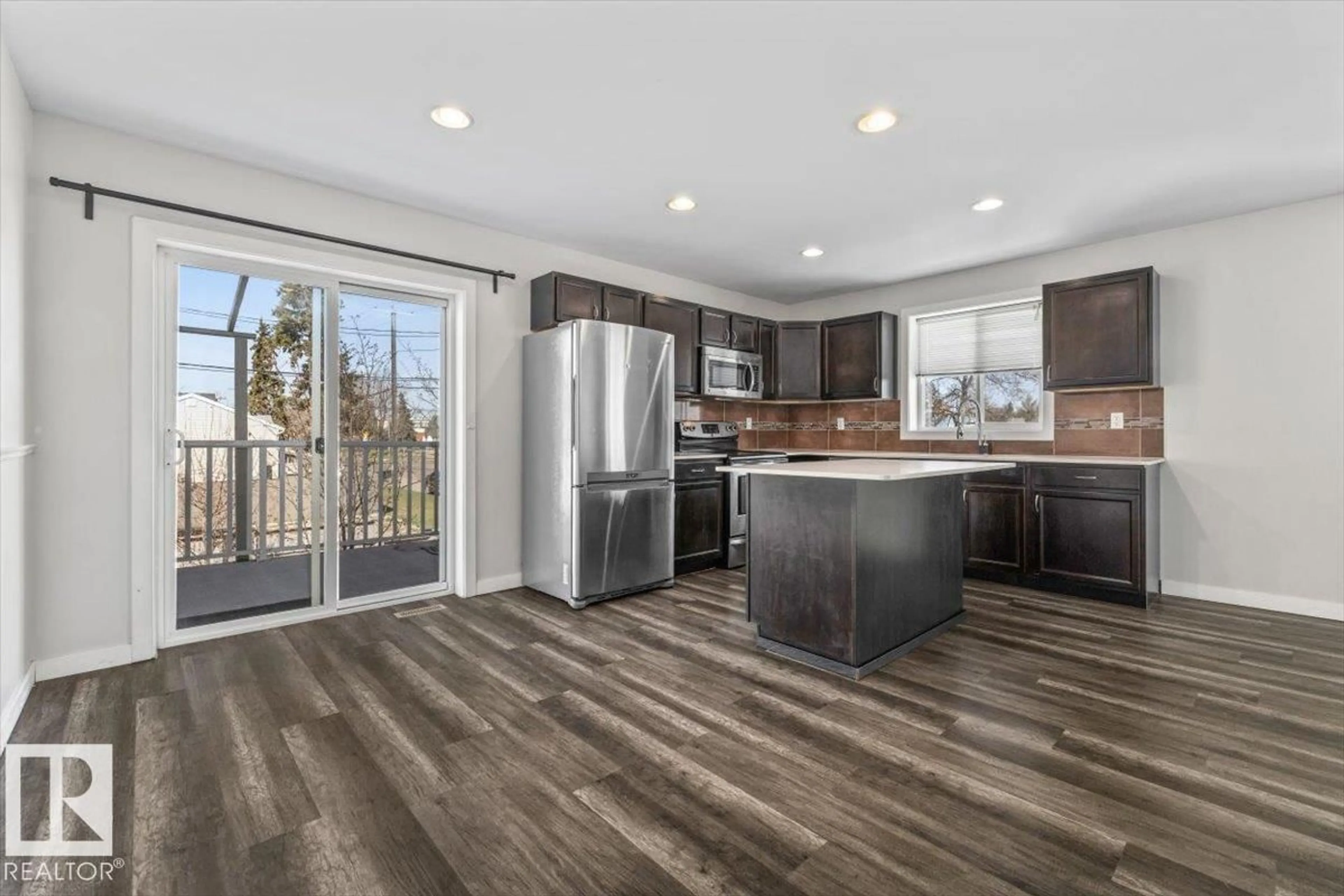 Open concept kitchen, wood/laminate floor for 15805 104 AV, Edmonton Alberta T5P2Y3