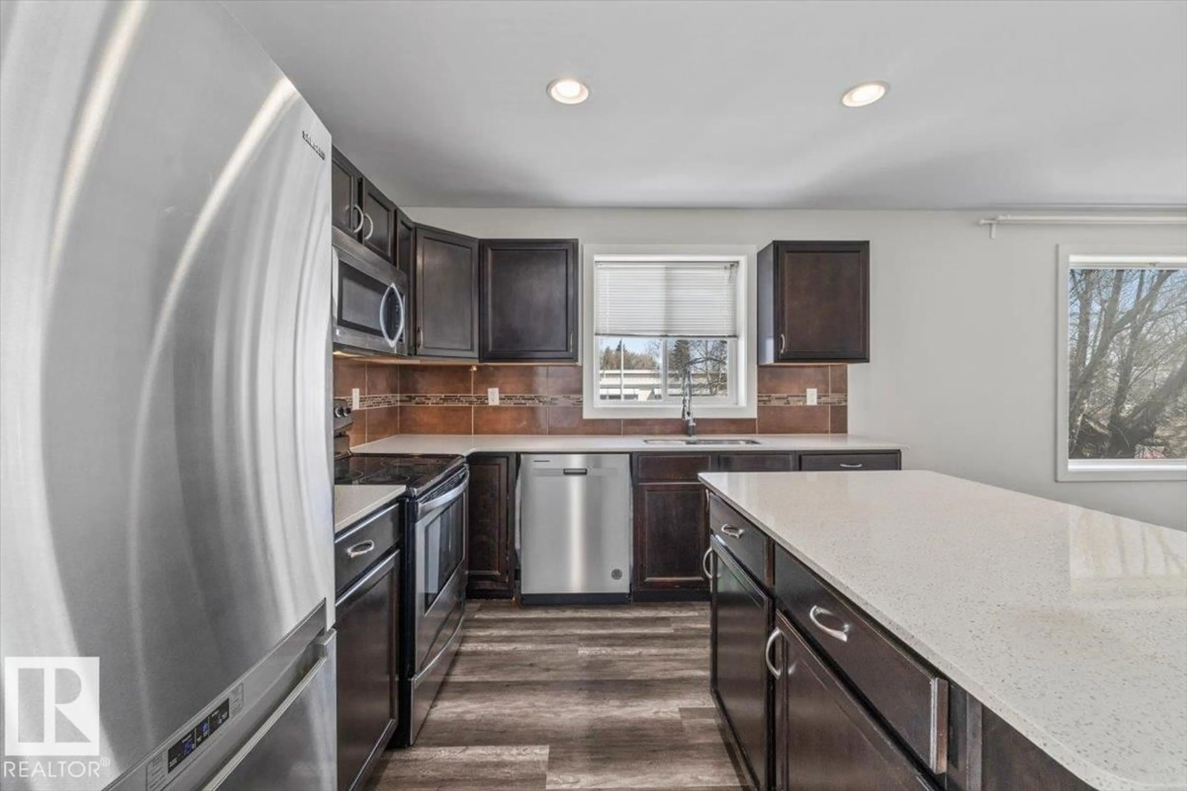 Open concept kitchen, ceramic/tile floor for 15805 104 AV, Edmonton Alberta T5P2Y3
