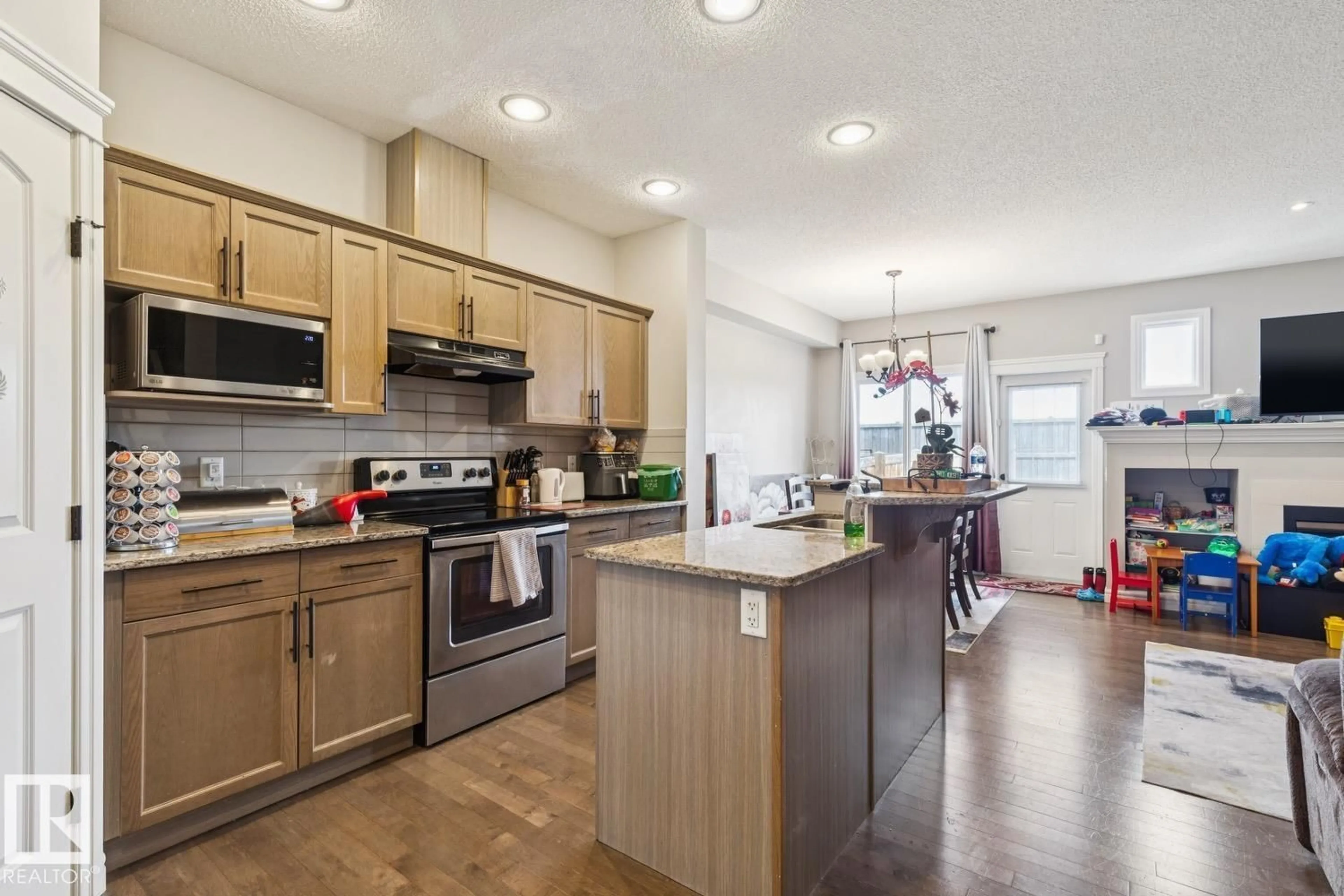 Open concept kitchen, wood/laminate floor for 17011 38 ST, Edmonton Alberta T5Y3S2