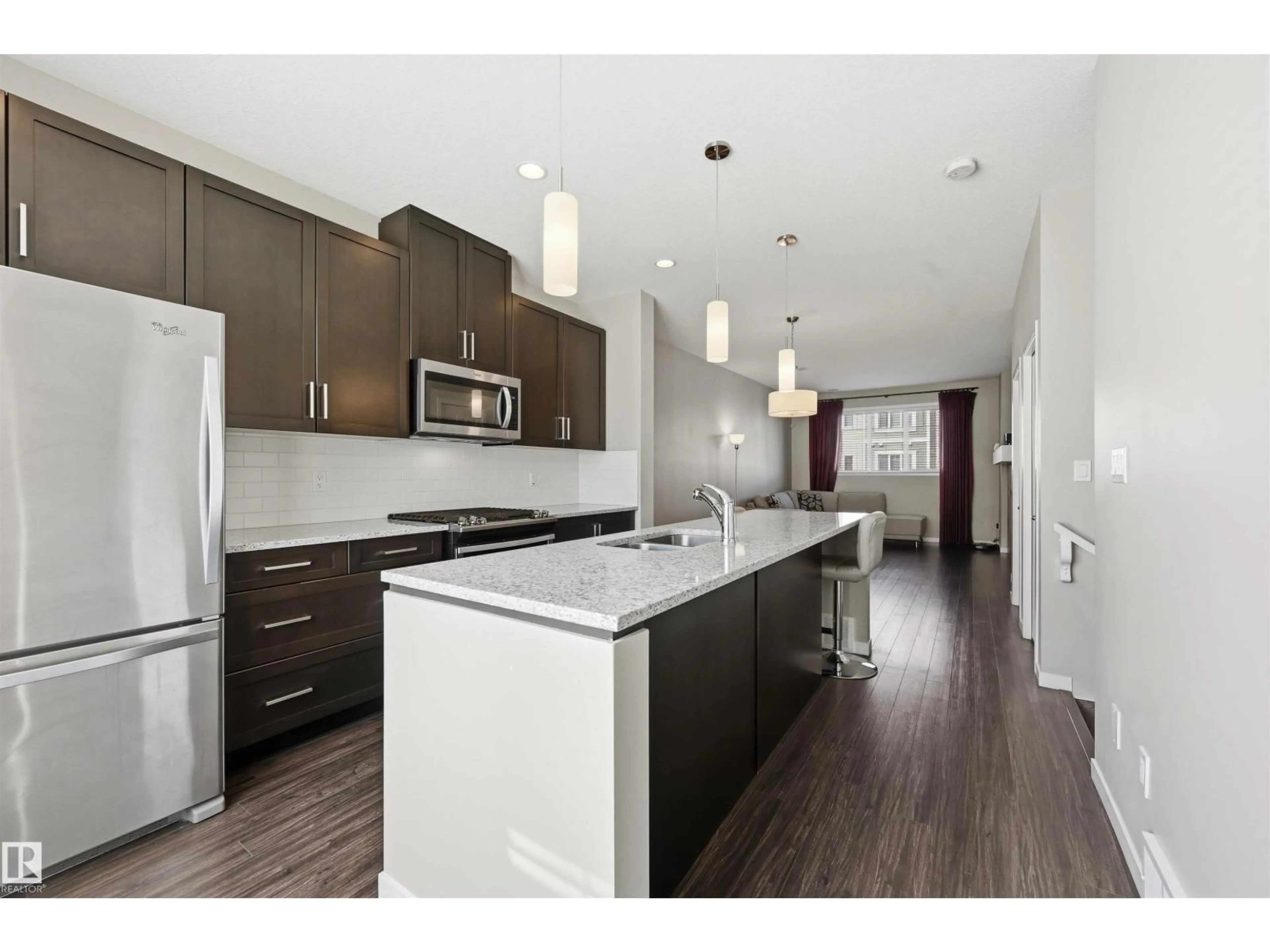 Open concept kitchen, wood/laminate floor for #4 - 320 SECORD BV, Edmonton Alberta T5T7E8