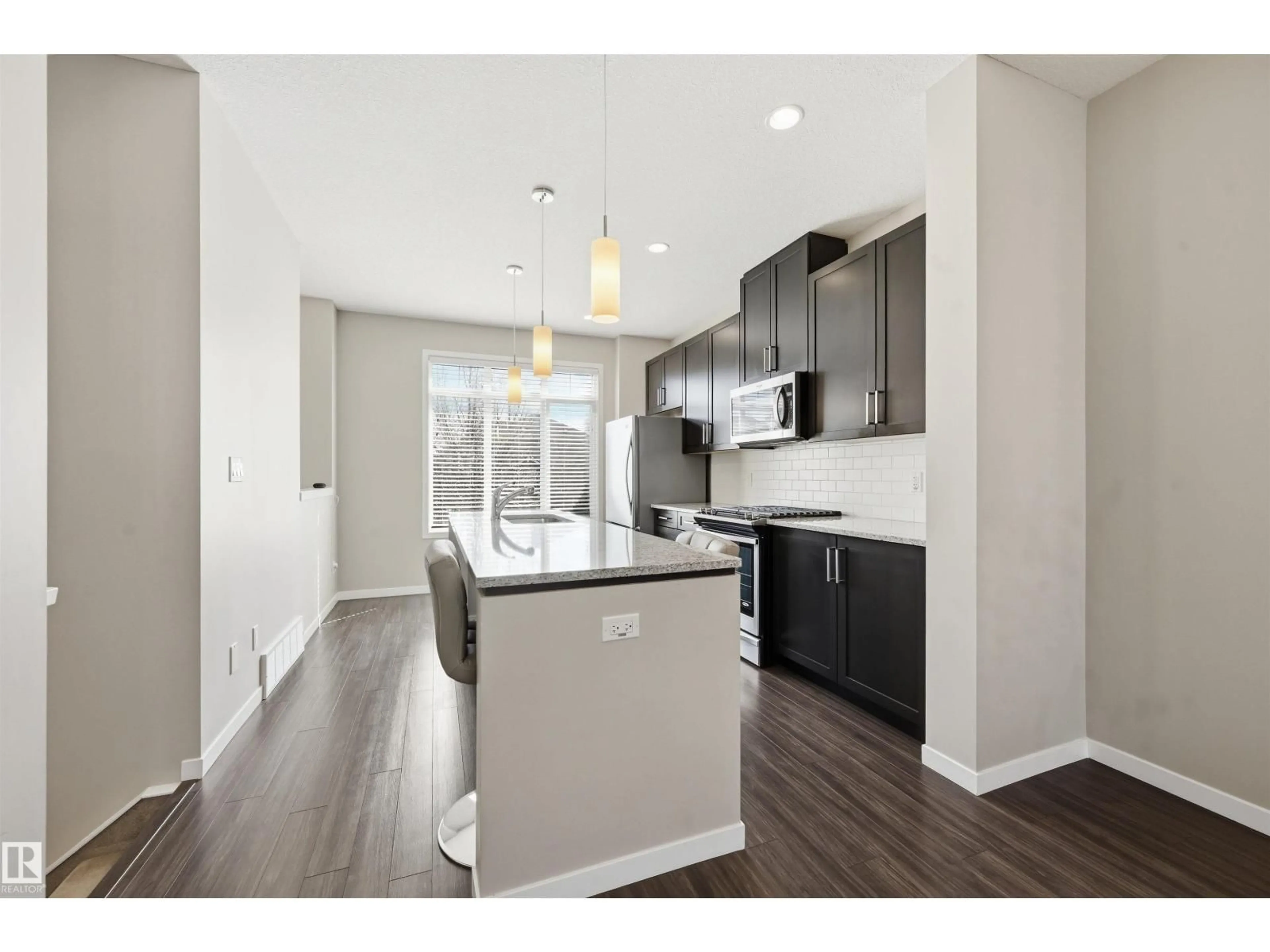 Open concept kitchen, wood/laminate floor for #4 - 320 SECORD BV, Edmonton Alberta T5T7E8