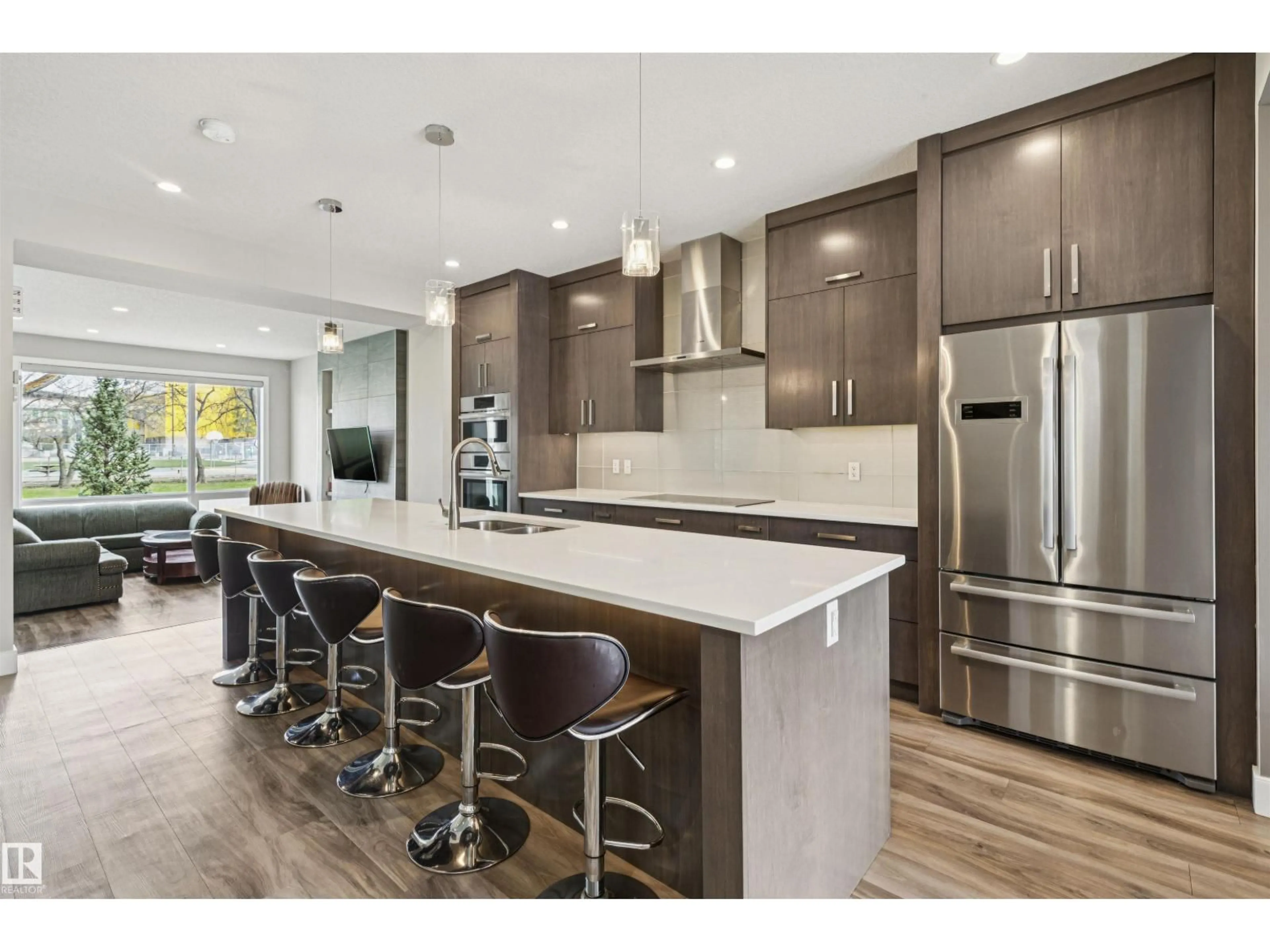 Open concept kitchen, wood/laminate floor for 8724 116 ST, Edmonton Alberta T6G1P7