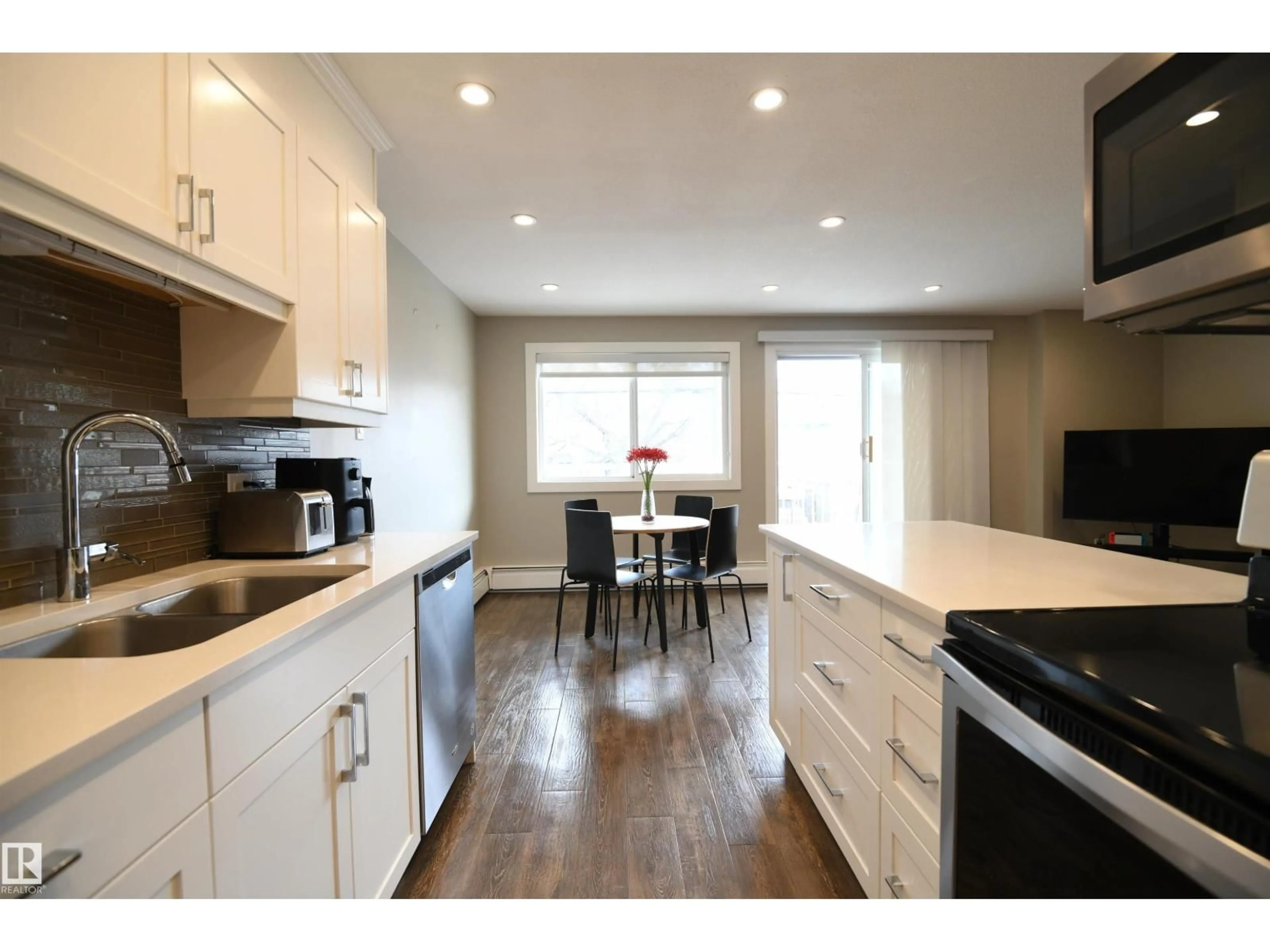 Open concept kitchen, wood/laminate floor for 206 - 8125 110 ST NW, Edmonton Alberta T6G2P3
