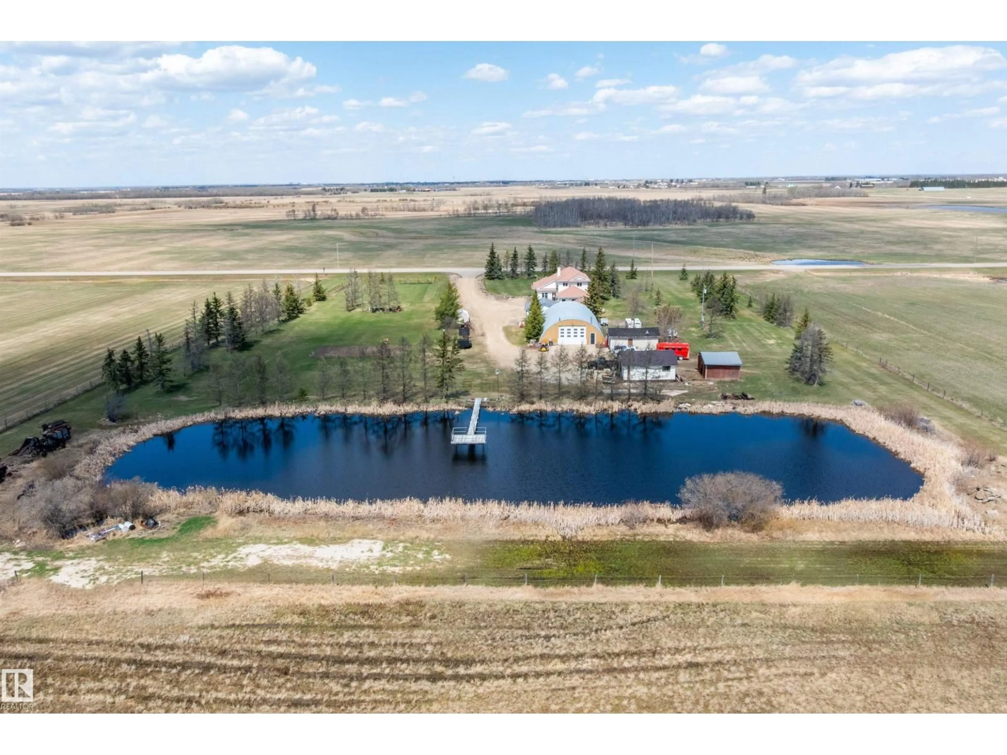 A pic from outside/outdoor area/front of a property/back of a property/a pic from drone, water/lake/river/ocean view for 25057 TWP RD, Rural Leduc County Alberta T4X2N5