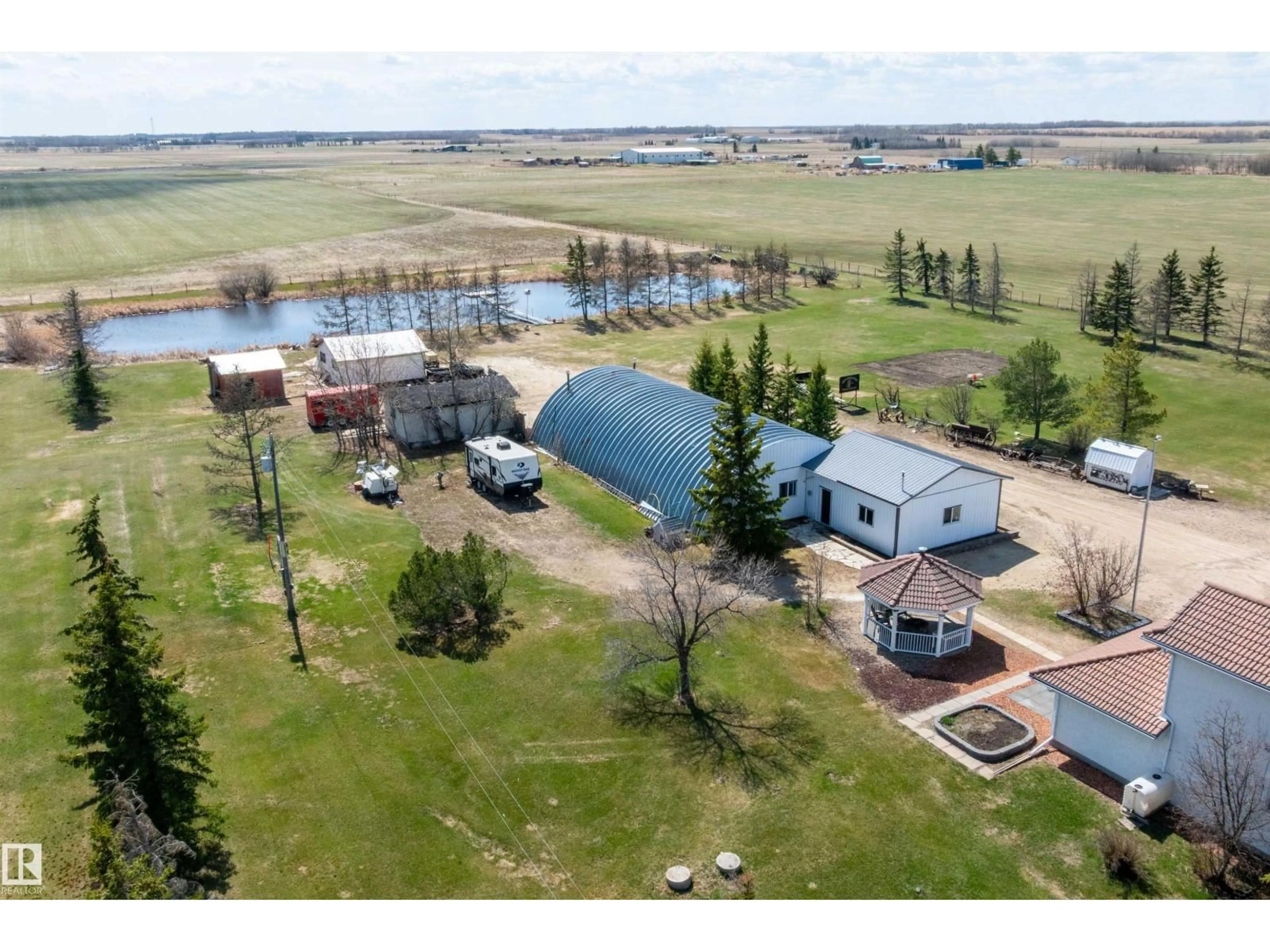 A pic from outside/outdoor area/front of a property/back of a property/a pic from drone, water/lake/river/ocean view for 25057 TWP RD, Rural Leduc County Alberta T4X2N5