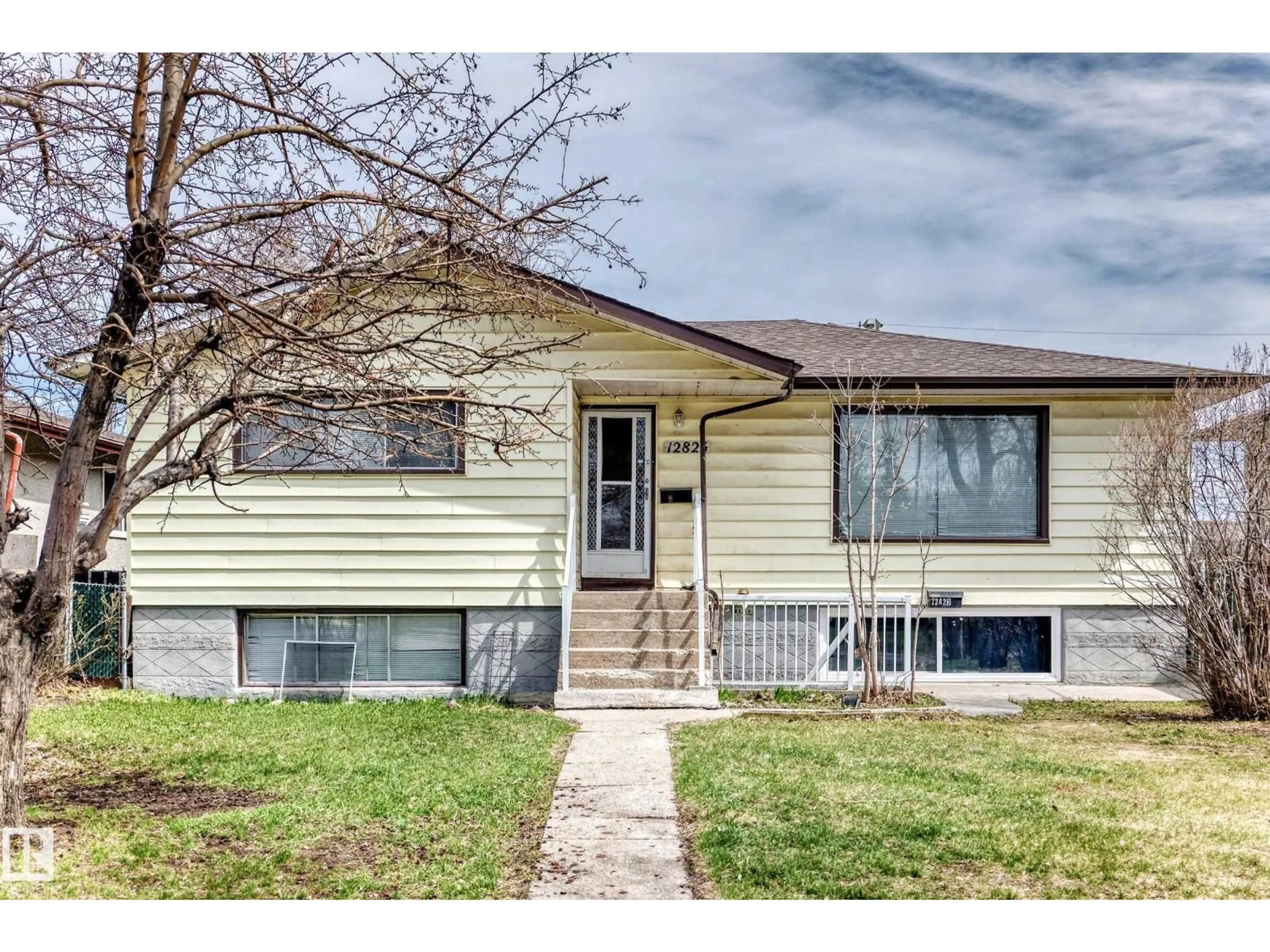 Home with vinyl exterior material, street for 12825 102 ST, Edmonton Alberta T5E4J2