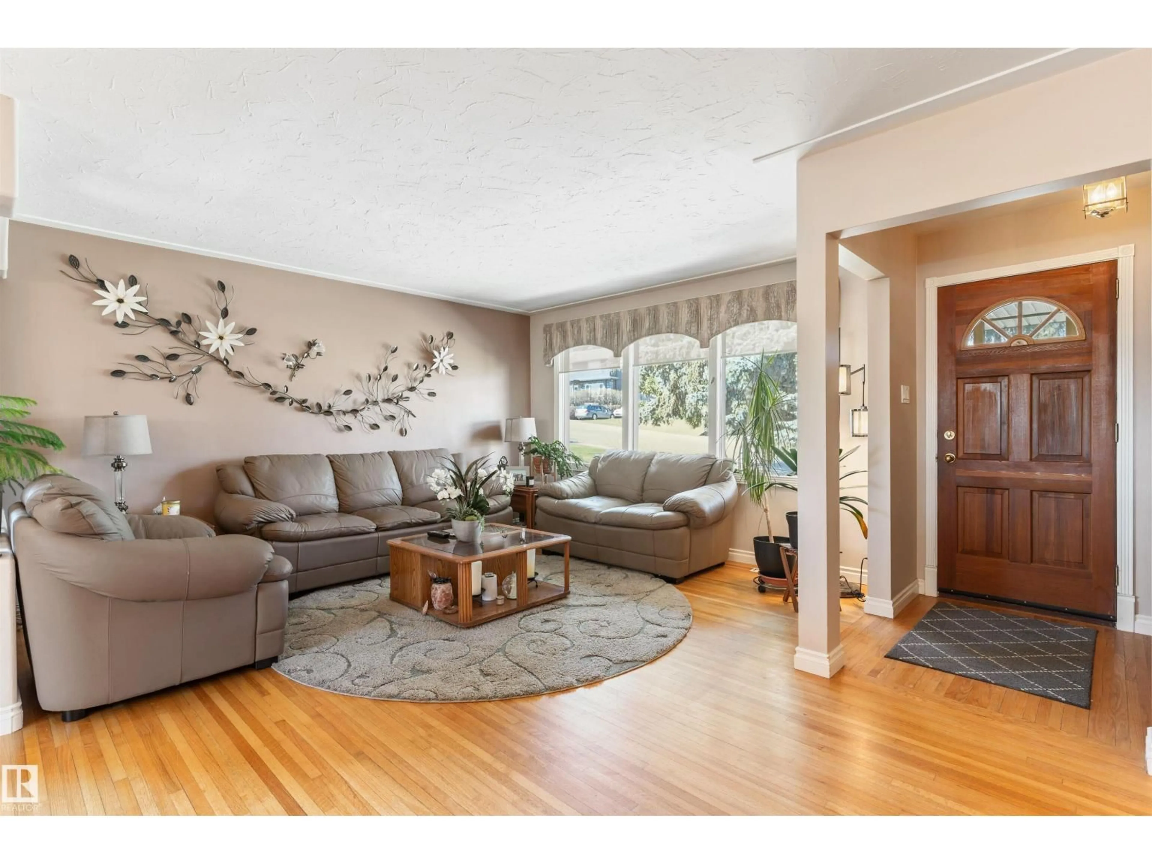Living room with furniture, wood/laminate floor for NW - 10803 52 ST, Edmonton Alberta T6A2H4