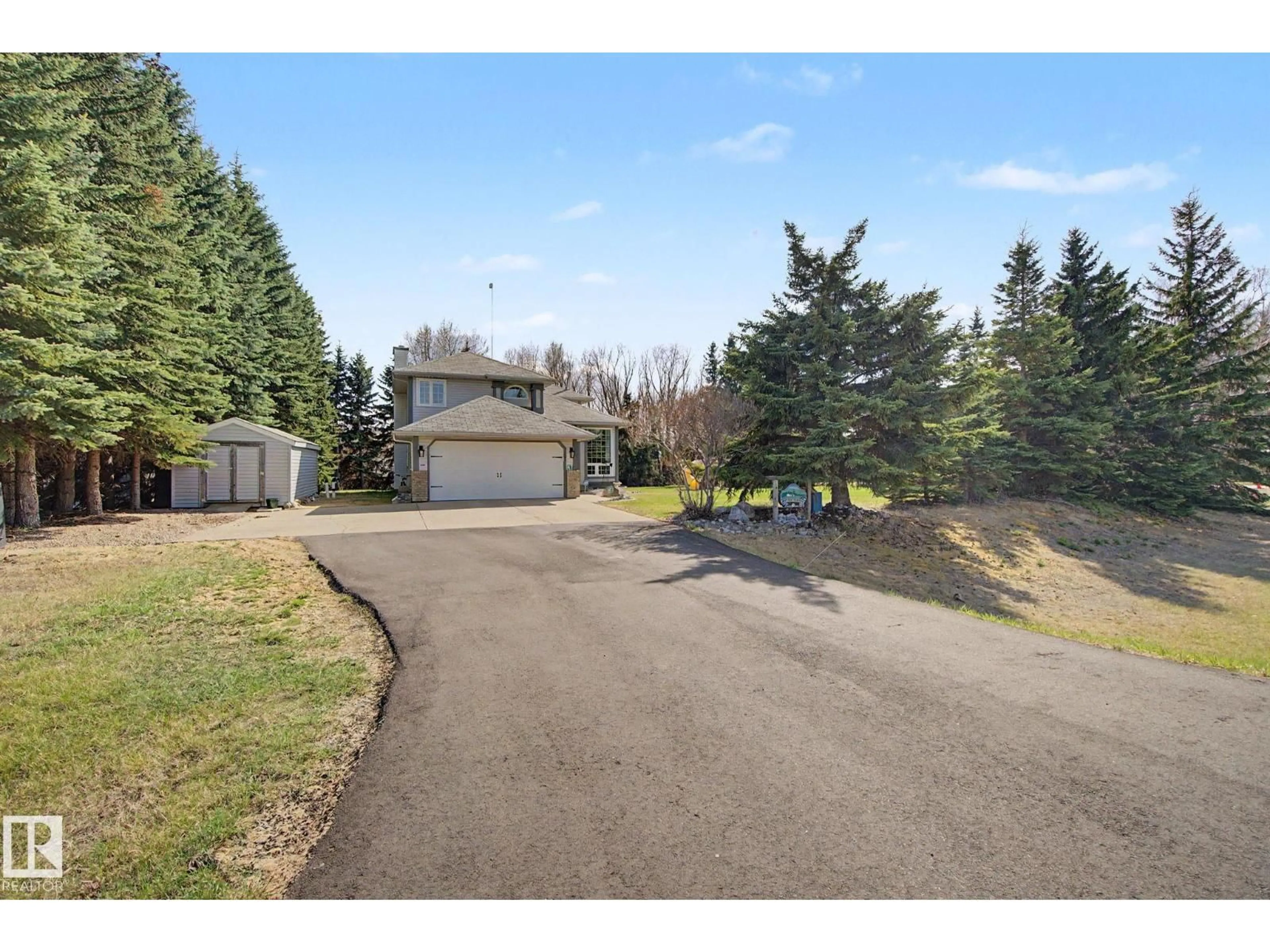 A pic from outside/outdoor area/front of a property/back of a property/a pic from drone, street for 47 - 26413 TWP ROAD 510, Rural Parkland County Alberta T7Y1E2