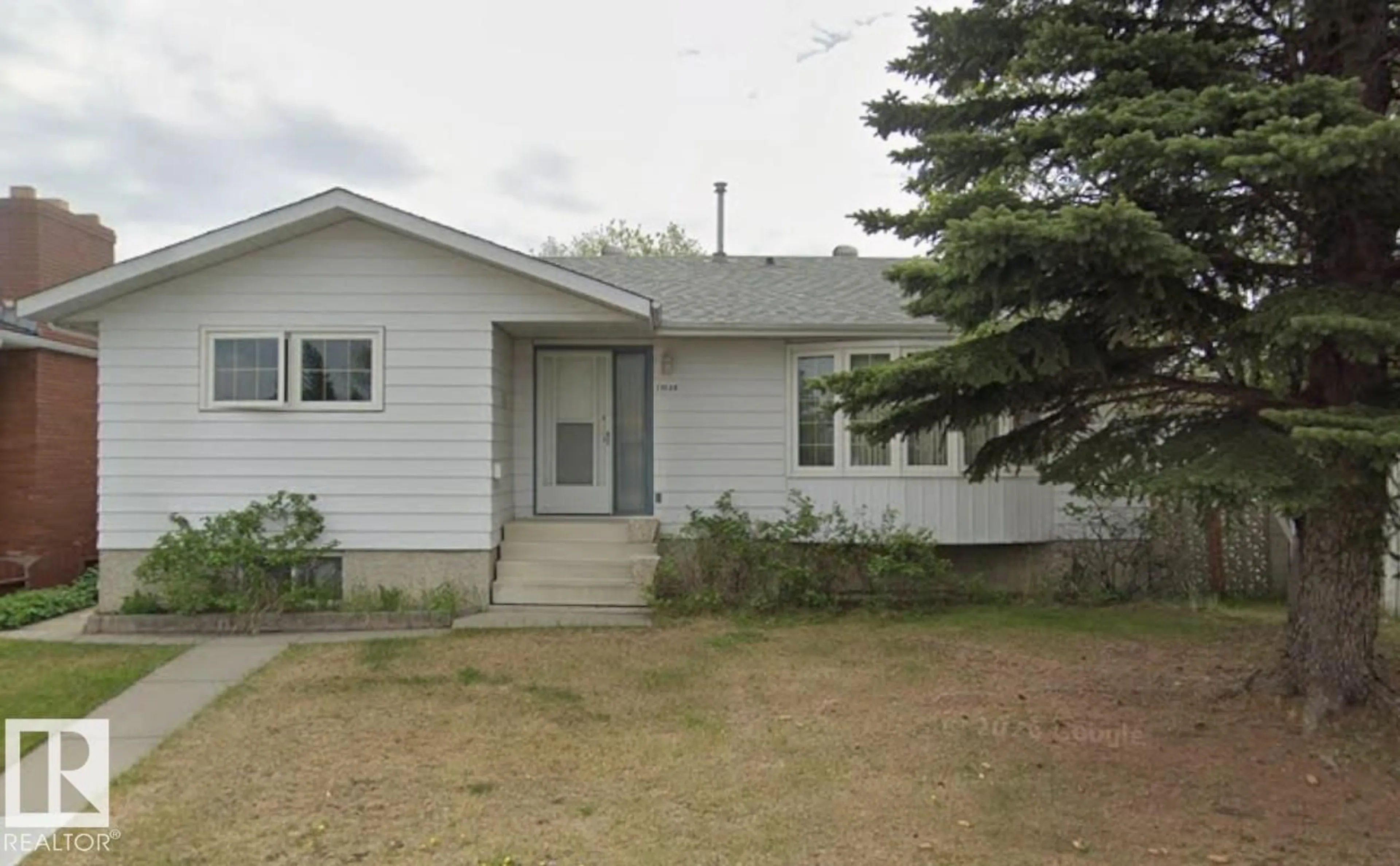 Home with vinyl exterior material, street for NW - 11035 166 AV, Edmonton Alberta T5X1Y2