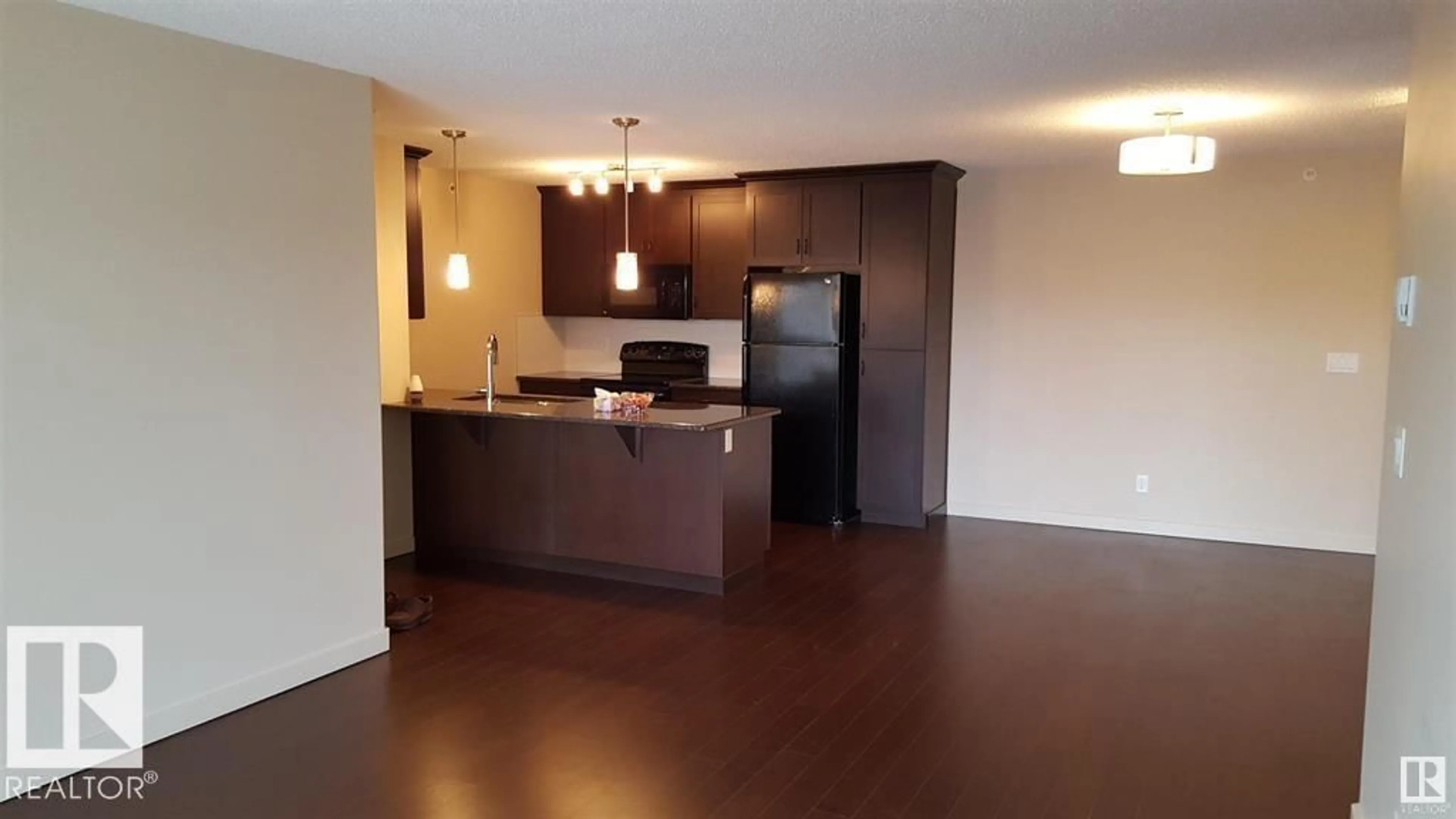 Open concept kitchen, wood/laminate floor for #437 - 6076 SCHONSEE WY, Edmonton Alberta T5Z0K8