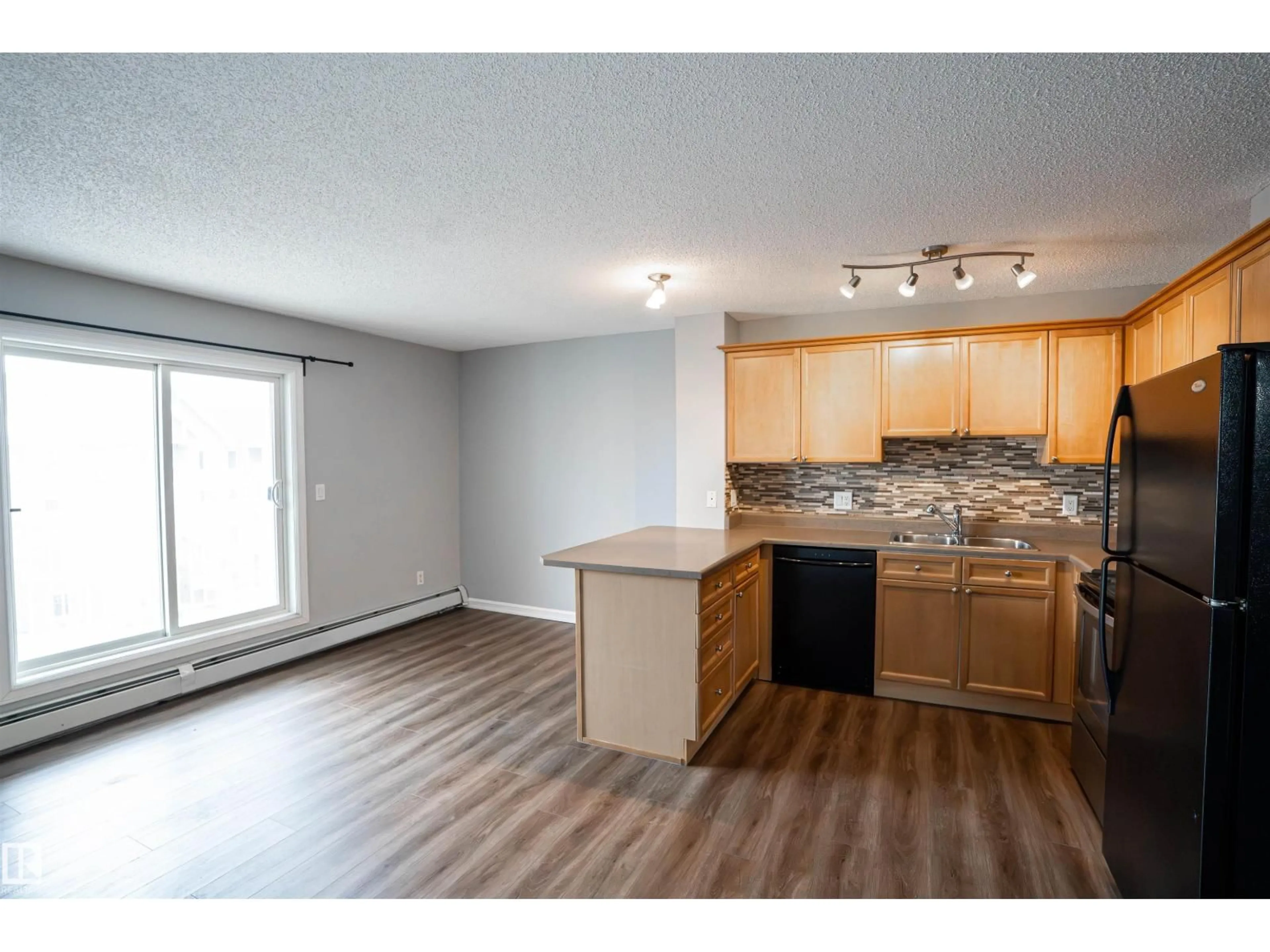 Open concept kitchen, wood/laminate floor for 4407 23 ST, Edmonton Alberta T6T0B6