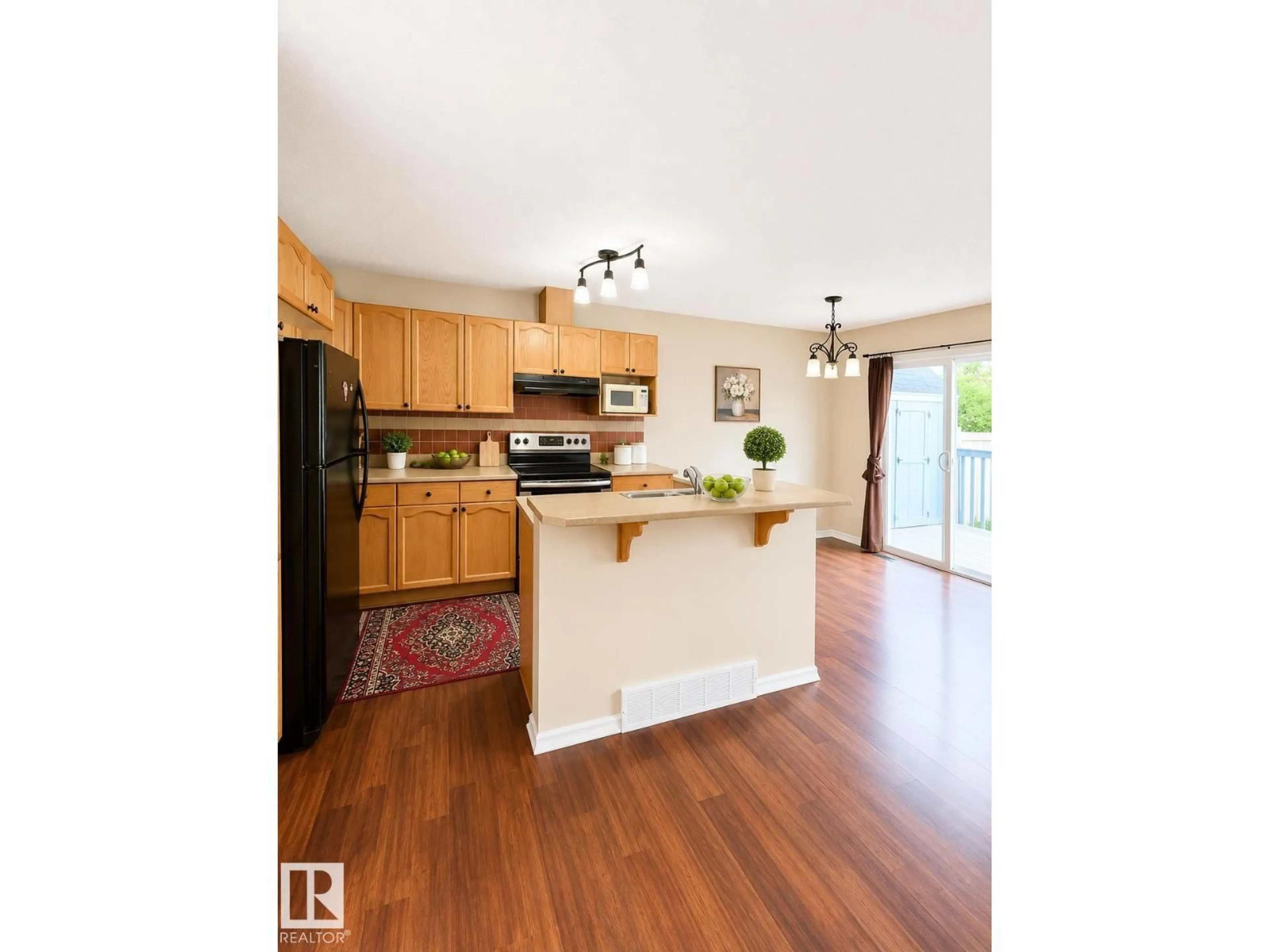 Open concept kitchen, wood/laminate floor for 704 83 ST, Edmonton Alberta T6X1L6