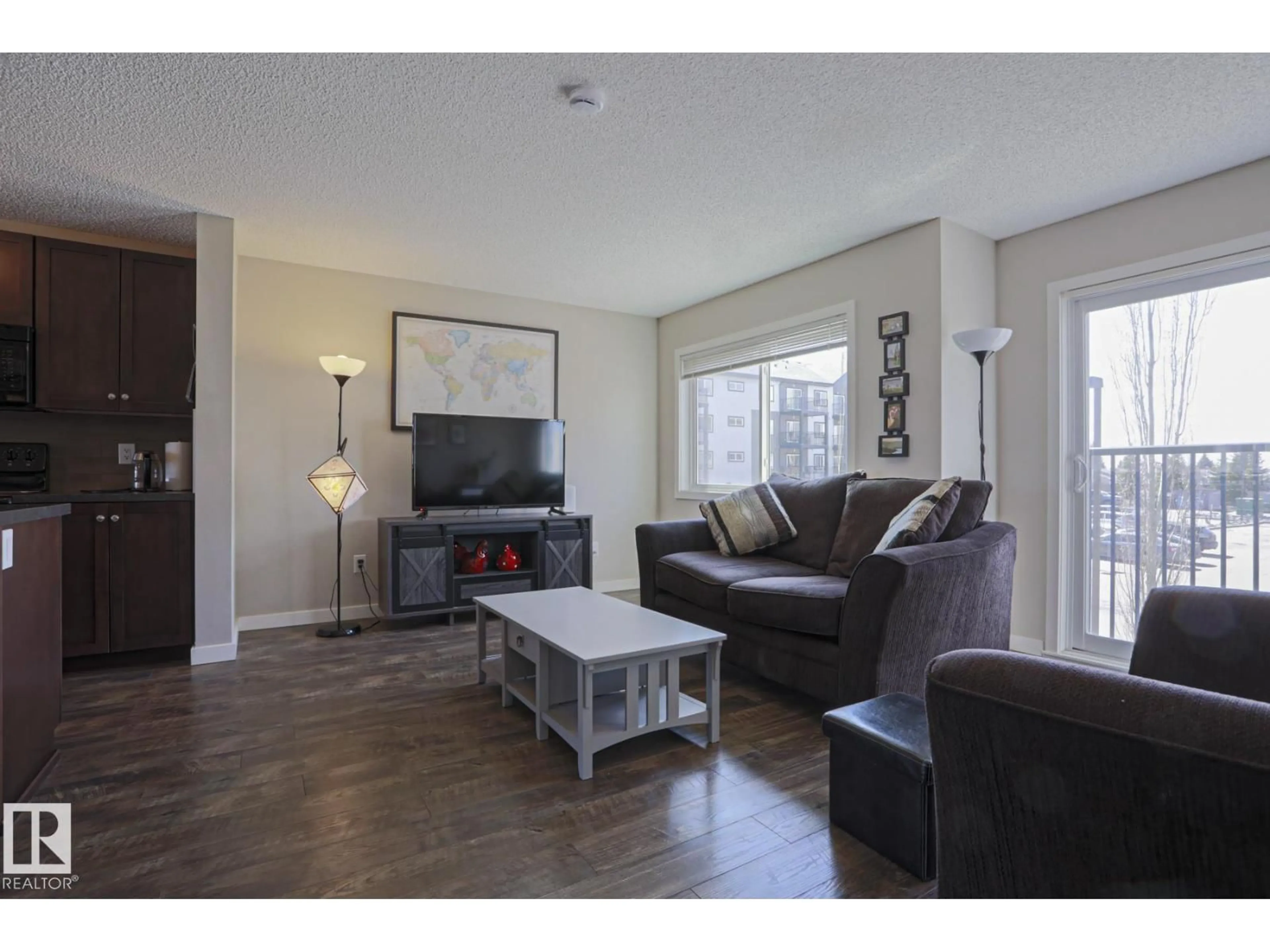 Living room with furniture, wood/laminate floor for NW - 1622 33A ST, Edmonton Alberta T6H0Y1