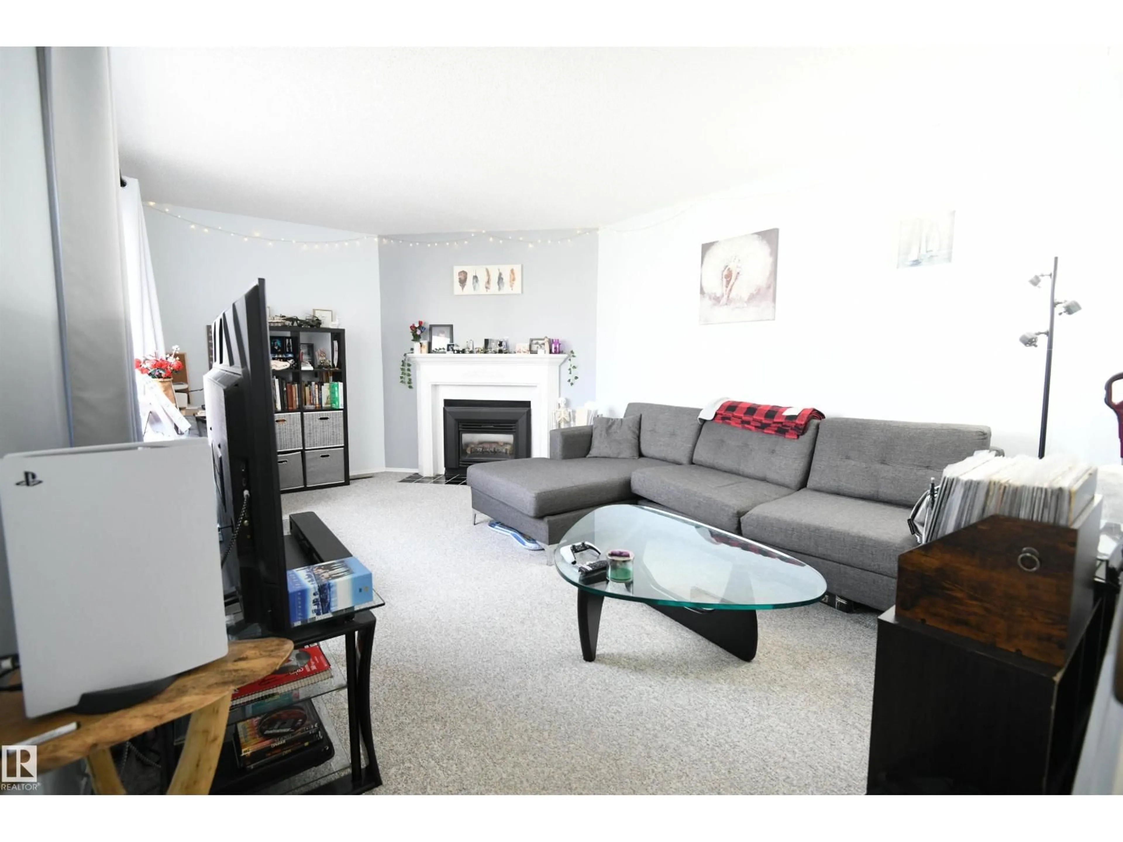 Living room with furniture, wood/laminate floor for 5823 RIVERBEND RD, Edmonton Alberta T6H5A8