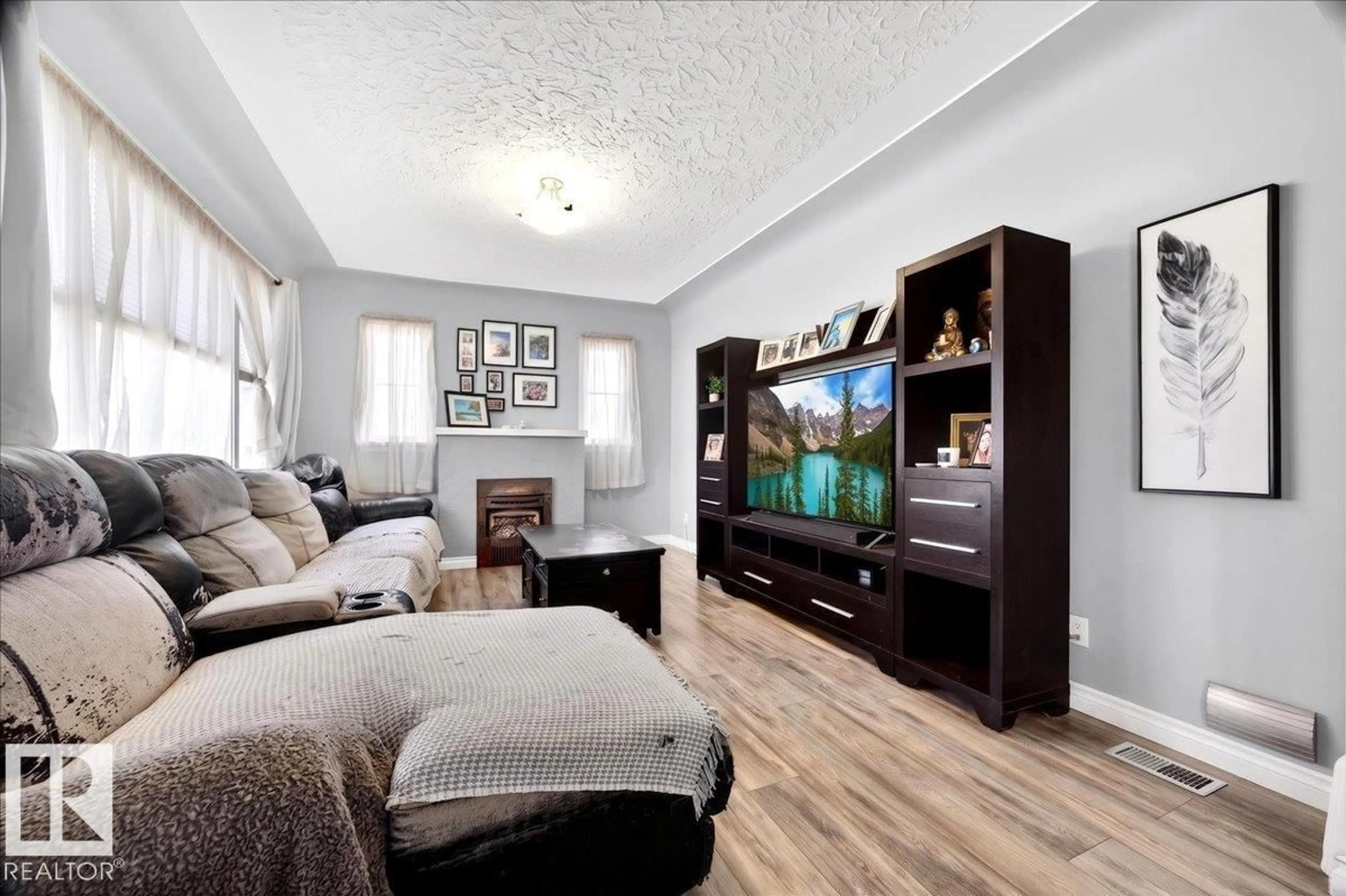 Living room with furniture, wood/laminate floor for 11645 125 ST, Edmonton Alberta T5M0N5