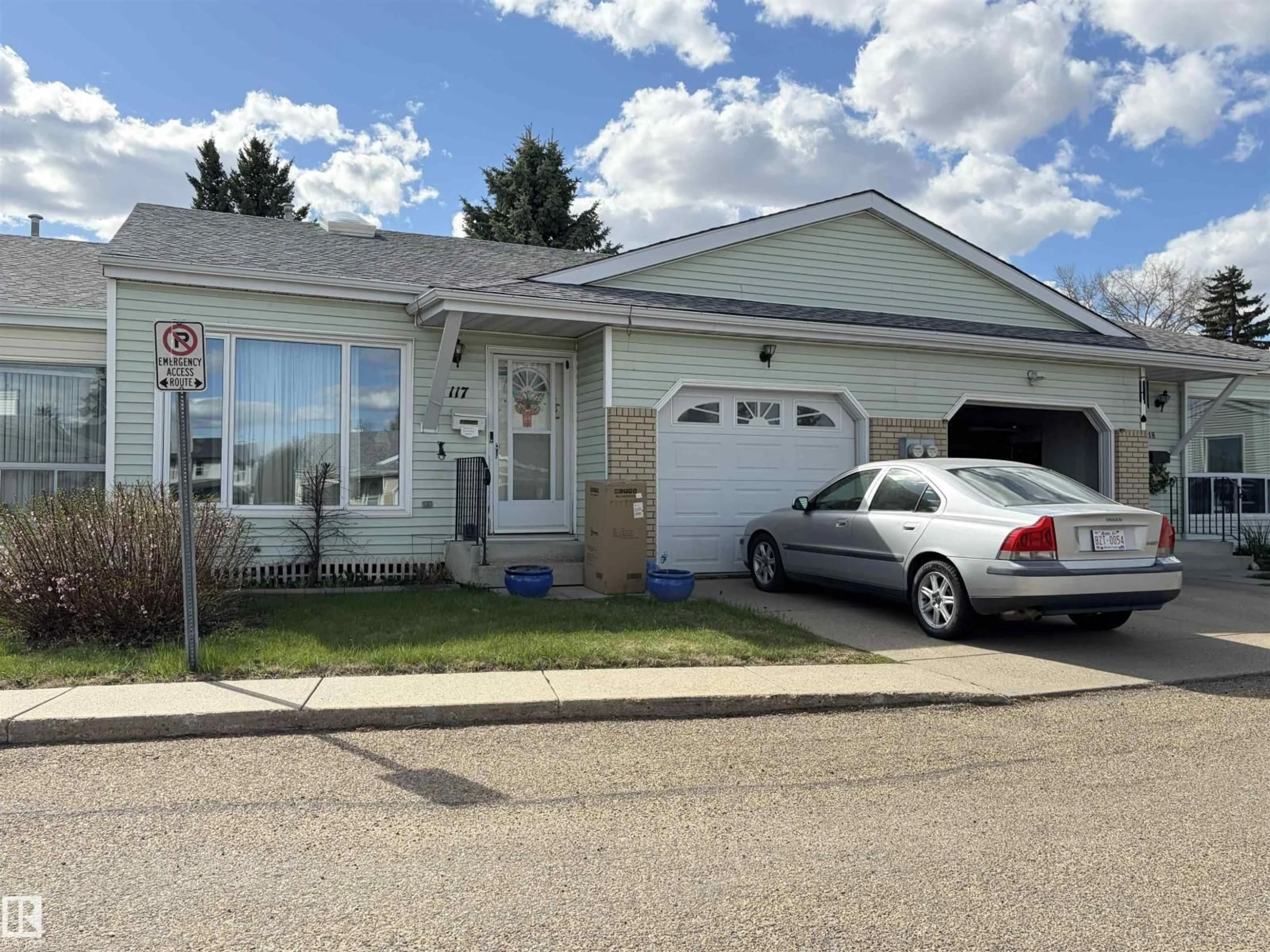 Home with vinyl exterior material, street for #117 - 17703 64 AV, Edmonton Alberta T5T5S1
