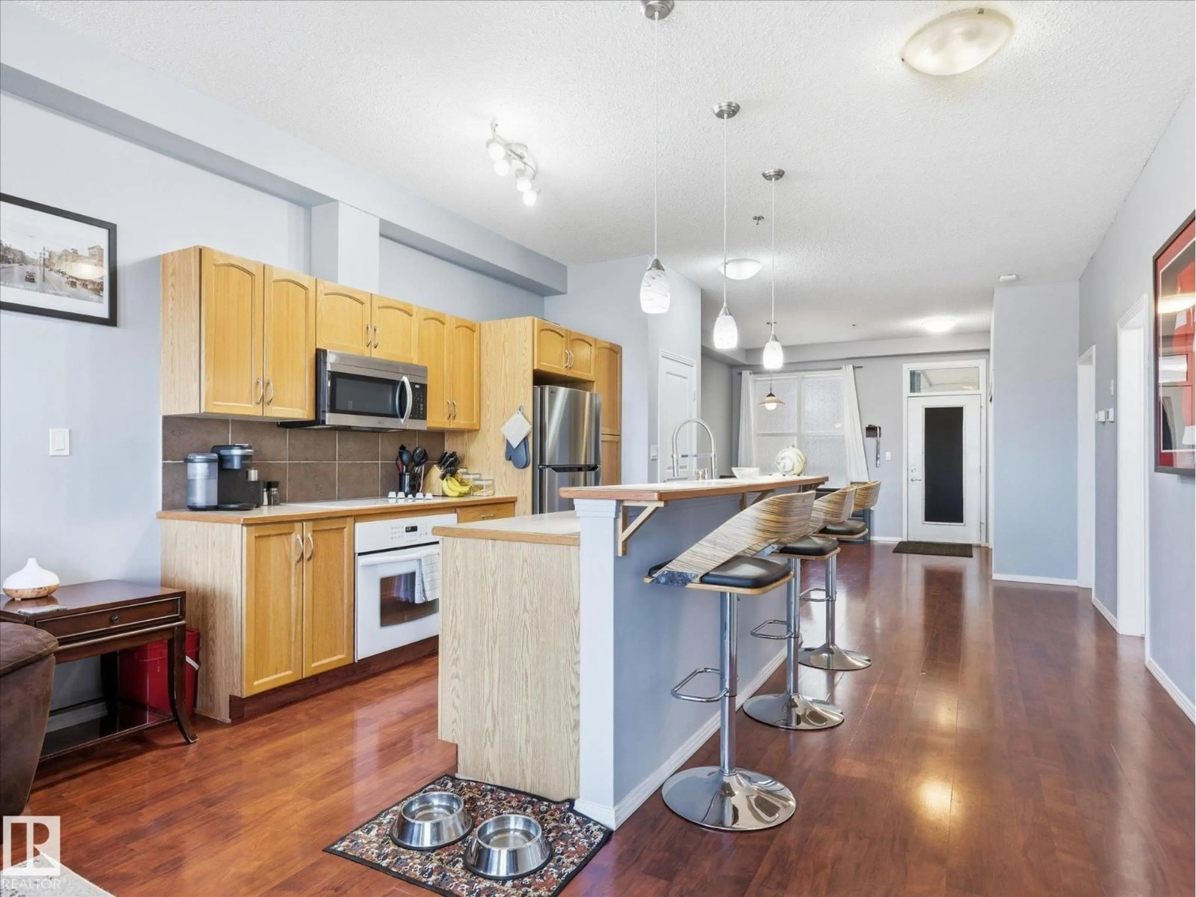 Open concept kitchen, wood/laminate floor for #268 - 4823 104A ST, Edmonton Alberta T6H0R5