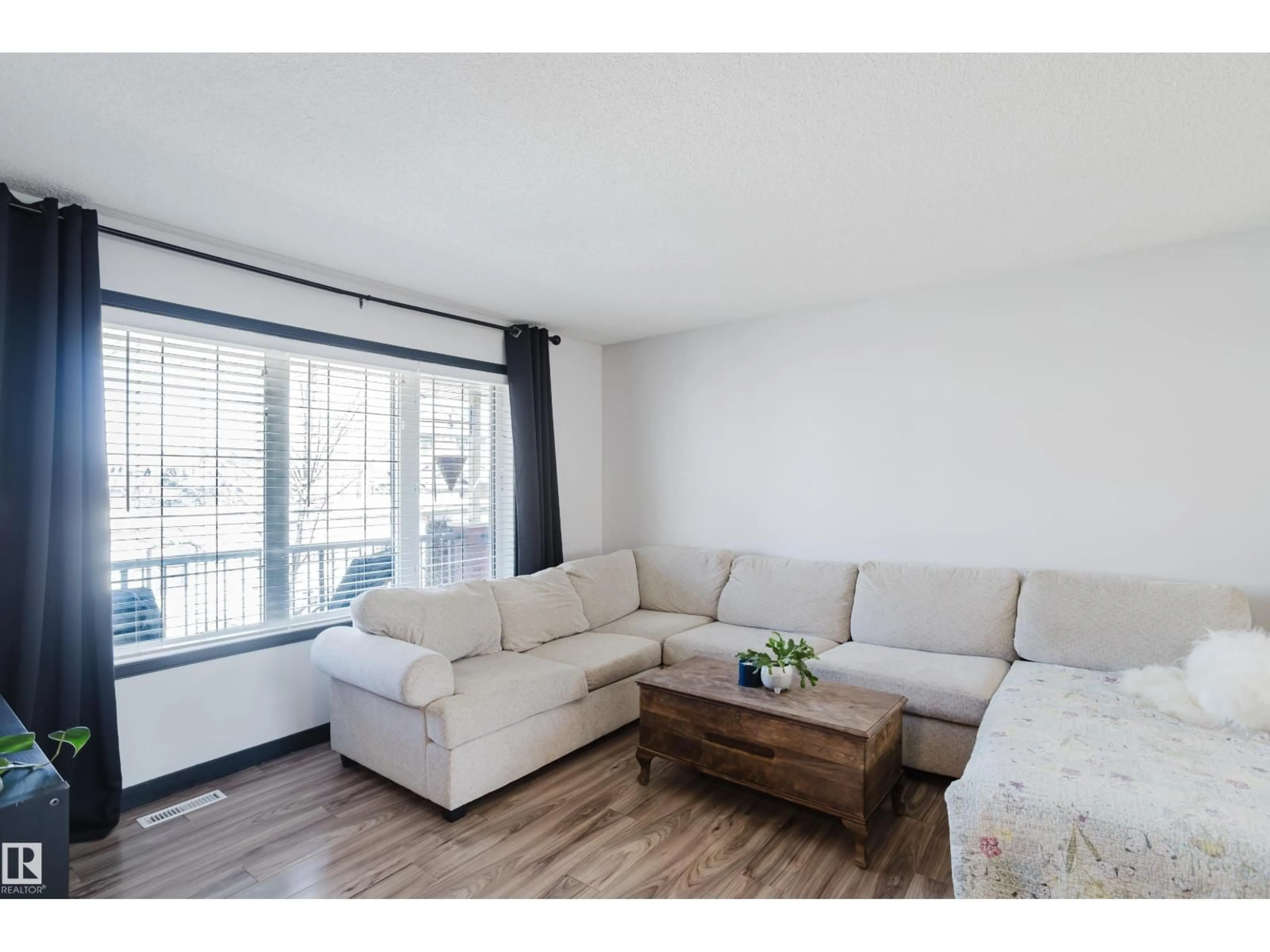 Living room with furniture, wood/laminate floor for 15 VENICE BV, Spruce Grove Alberta T7X4P6