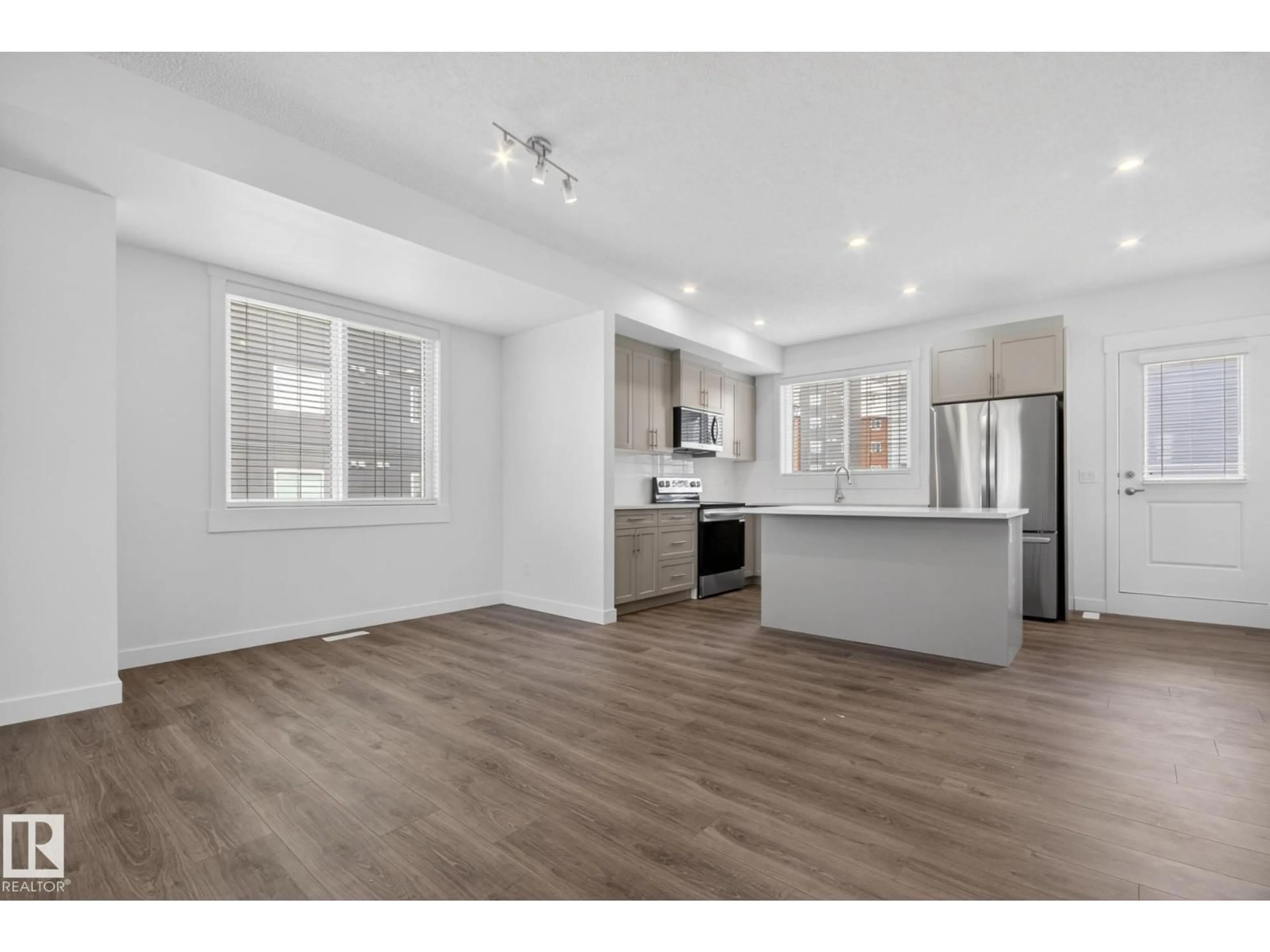 Open concept kitchen, wood/laminate floor for 3605 JAMES MOWATT TR, Edmonton Alberta T6W1A8