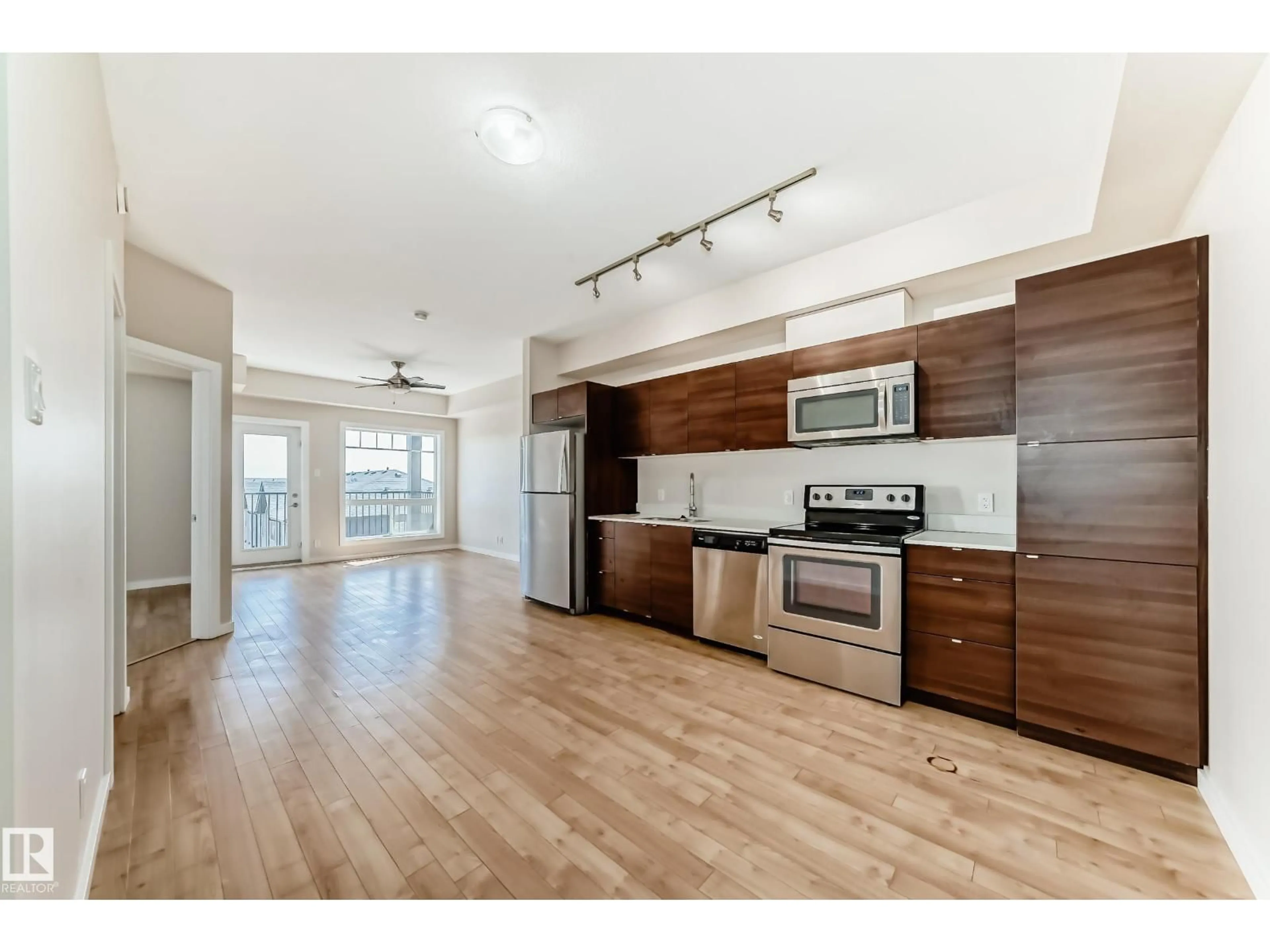 Open concept kitchen, wood/laminate floor for #413 - 9519 160 AV, Edmonton Alberta T5Z0N1